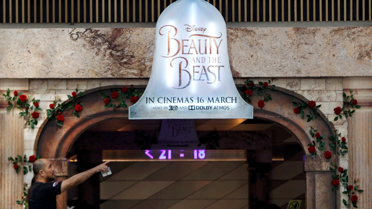 A man walks in front of the a movie advertising board at shopping mall in Kuala Lumpur, Malaysia Tuesday, March 14, 2017. The Malaysian Censorship Board (LPF) today said Disney's new movie, Beauty and the Beast has been approved with minor cut before its initial March 16 release date. Photo: AP