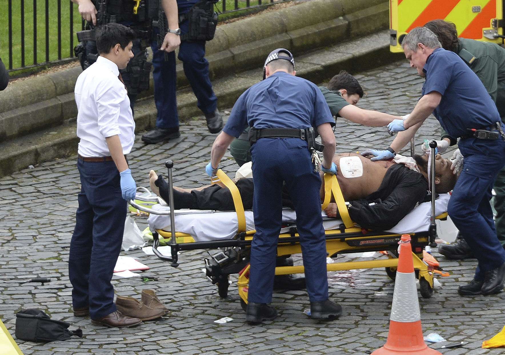 Press Association news agency photos believed to be of the knifeman lying on an ambulance stretcher showed a burly man with black clothes and a beard. Photo: PA