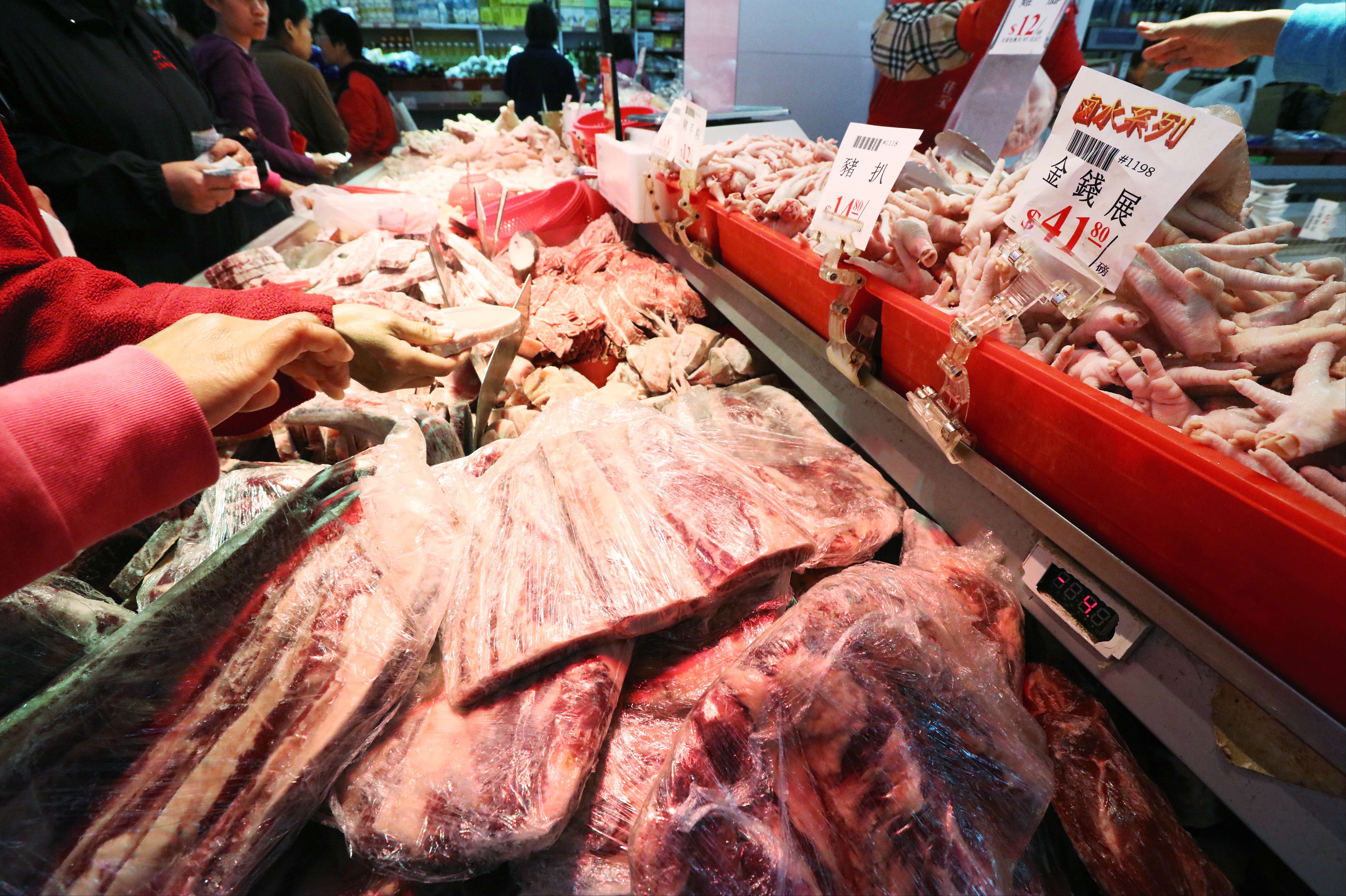 Customers choosing frozen meat at a market in North Point on Wednesday. Photo: Felix Wong