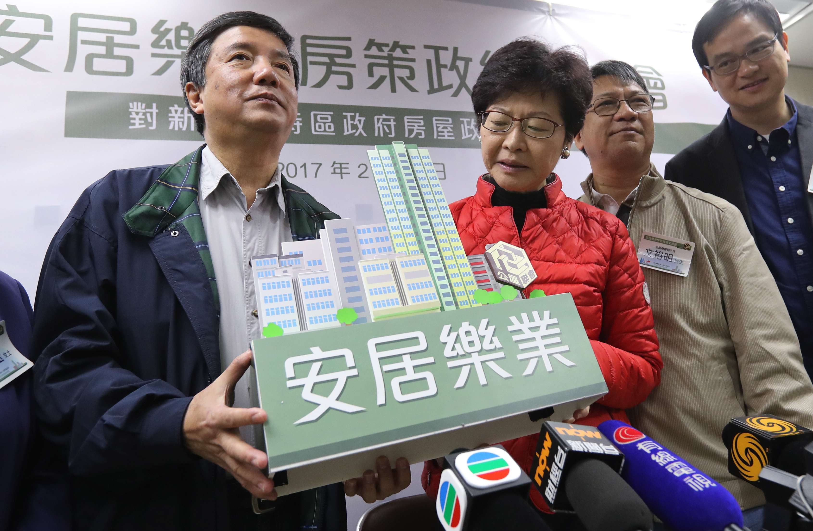 Then chief executive hopeful Carrie Lam with Wong Kwun (left), chairman of the Federation of Public Housing Estates, in Kwun Tong on February 18. In her election platform, Lam pledged to improve access to housing, including for first-time homebuyers in the “sandwich class” who are ineligible for public housing. Photo: Edward Wong