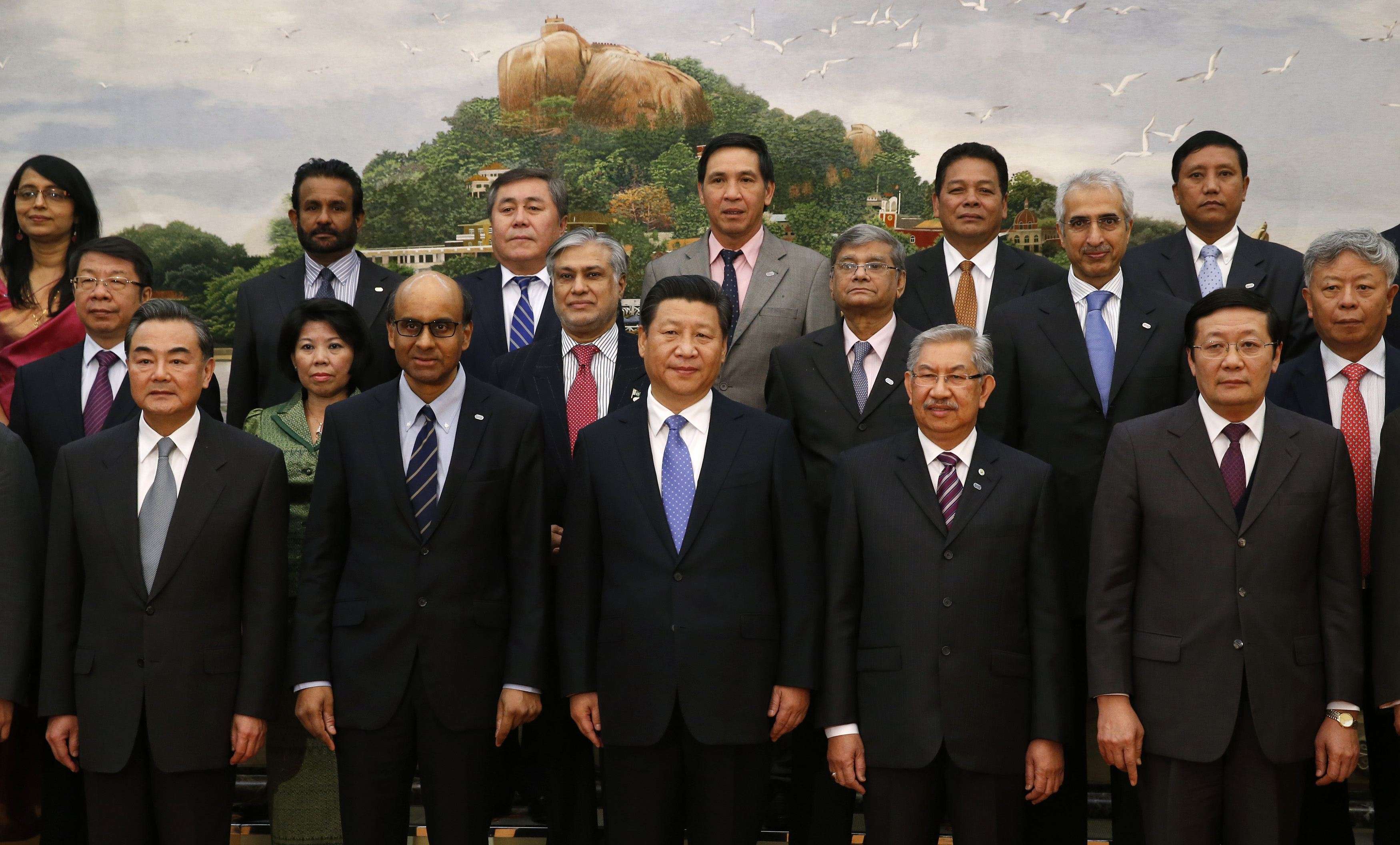President Xi Jinping and Foreign Minister Wang Yi (far left) with delegates from member states at the launch of the Asian Infrastructure Investment Bank, in the Great Hall of the People on October 24, 2014. Photo: Reuters