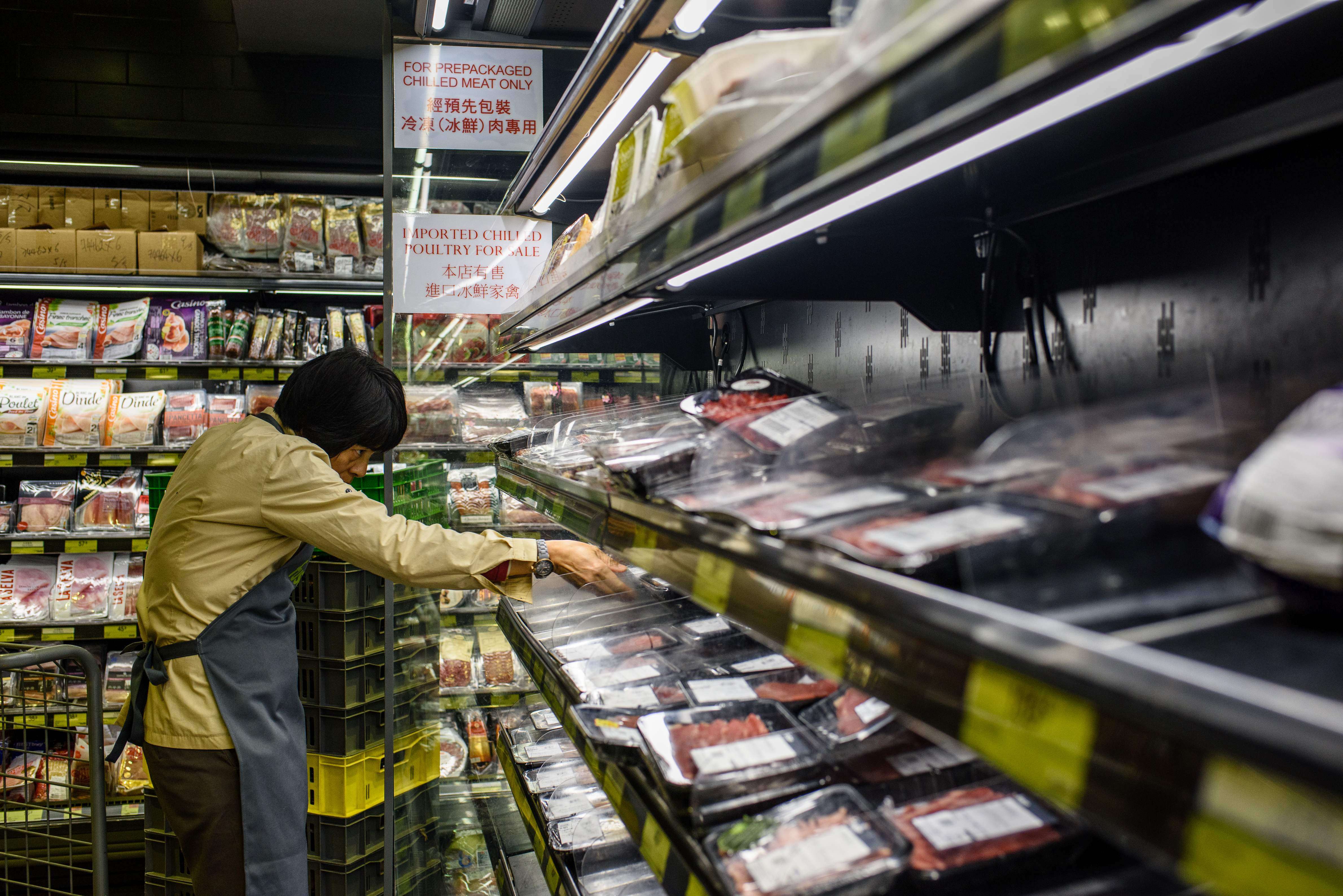 Supermarket employees cleared shelves of Brazilian meat products. Photo: AFP