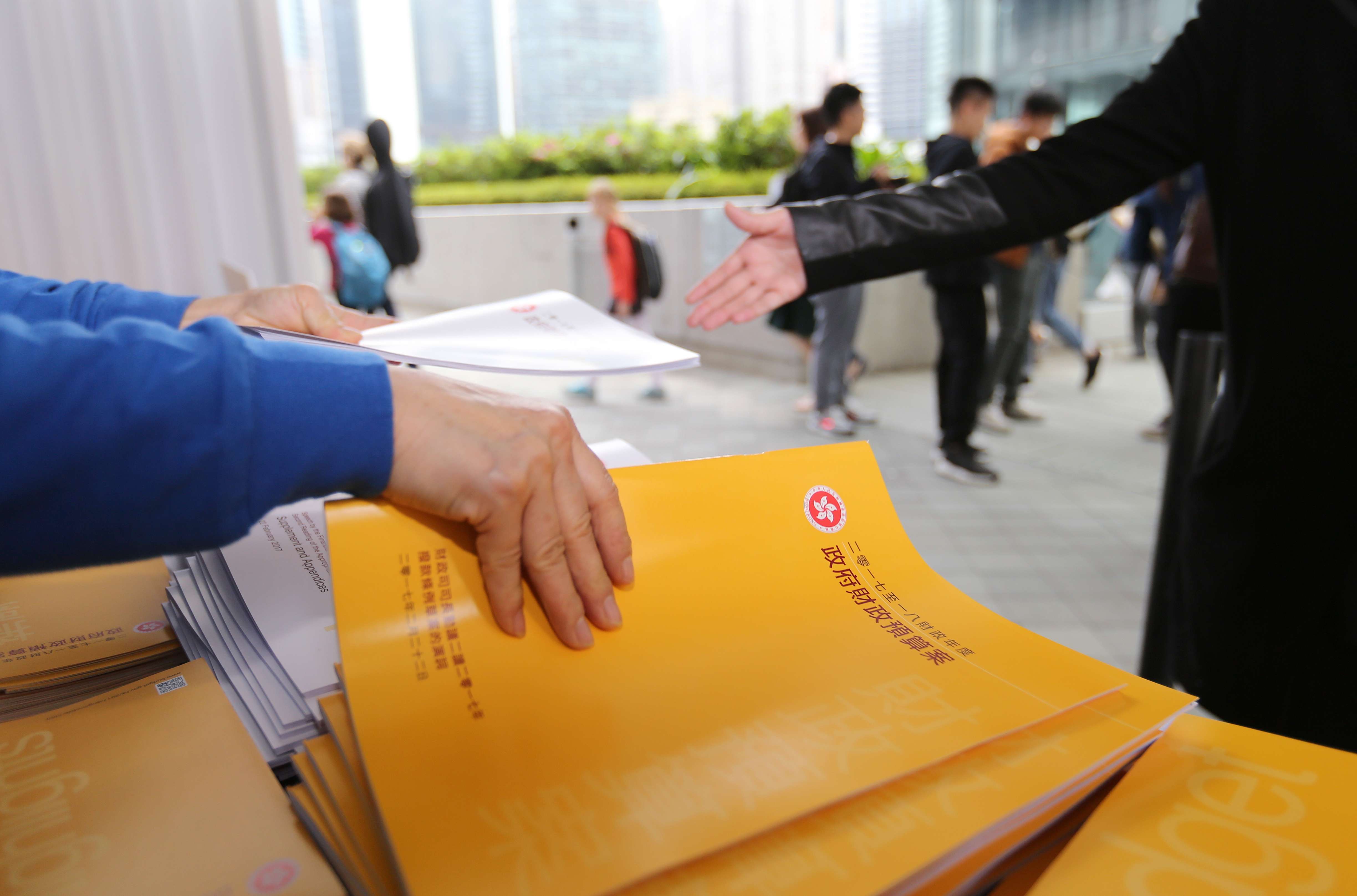 Leaflets of this year’s budget being handed out to members of the public in Tamar. Photo: Xiaomei Chen