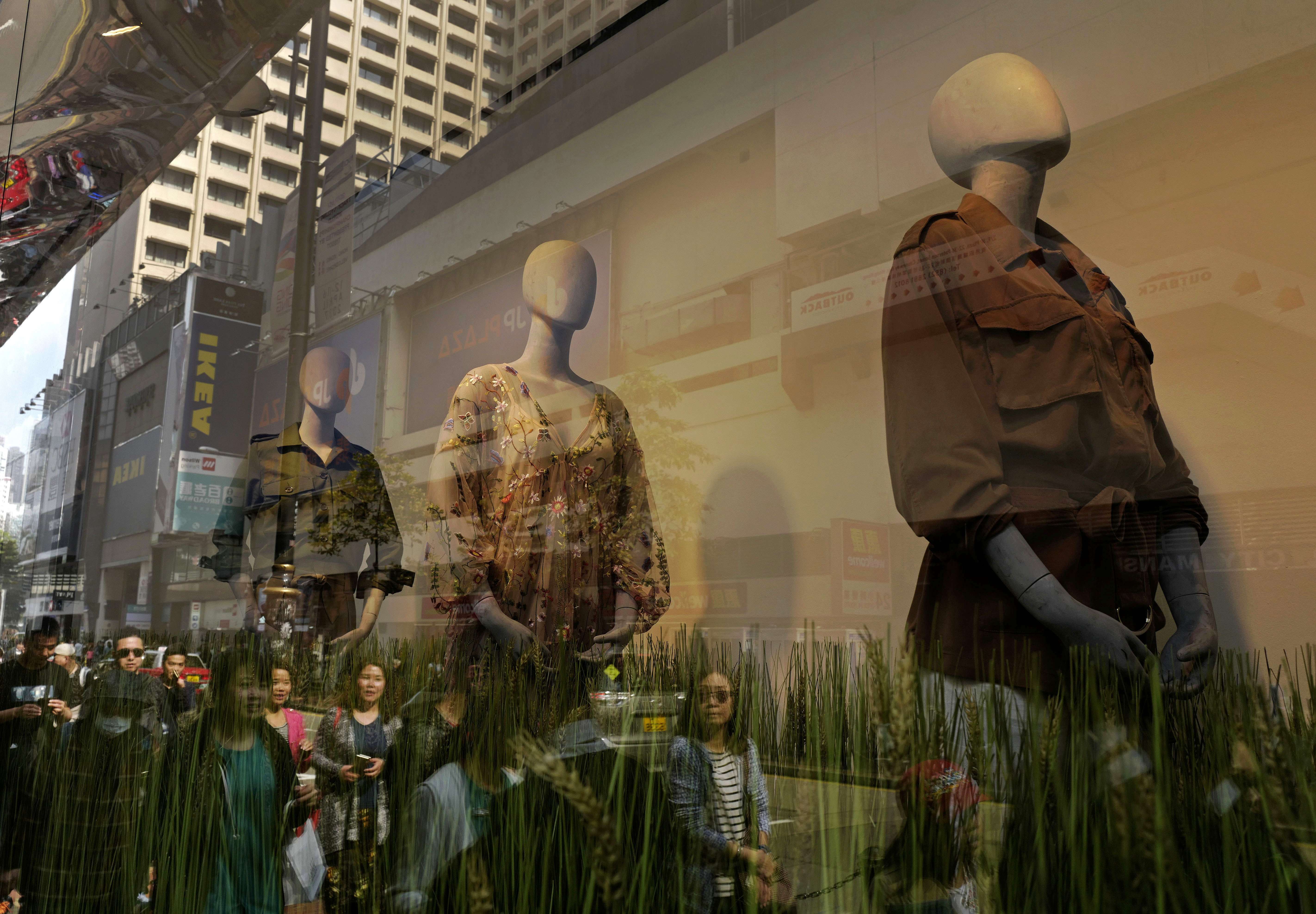 People walk past a store display in Hong Kong. It appears many Hong Kong Chinese do not respect or recognise the value of ethnic diversity. Photo: AP