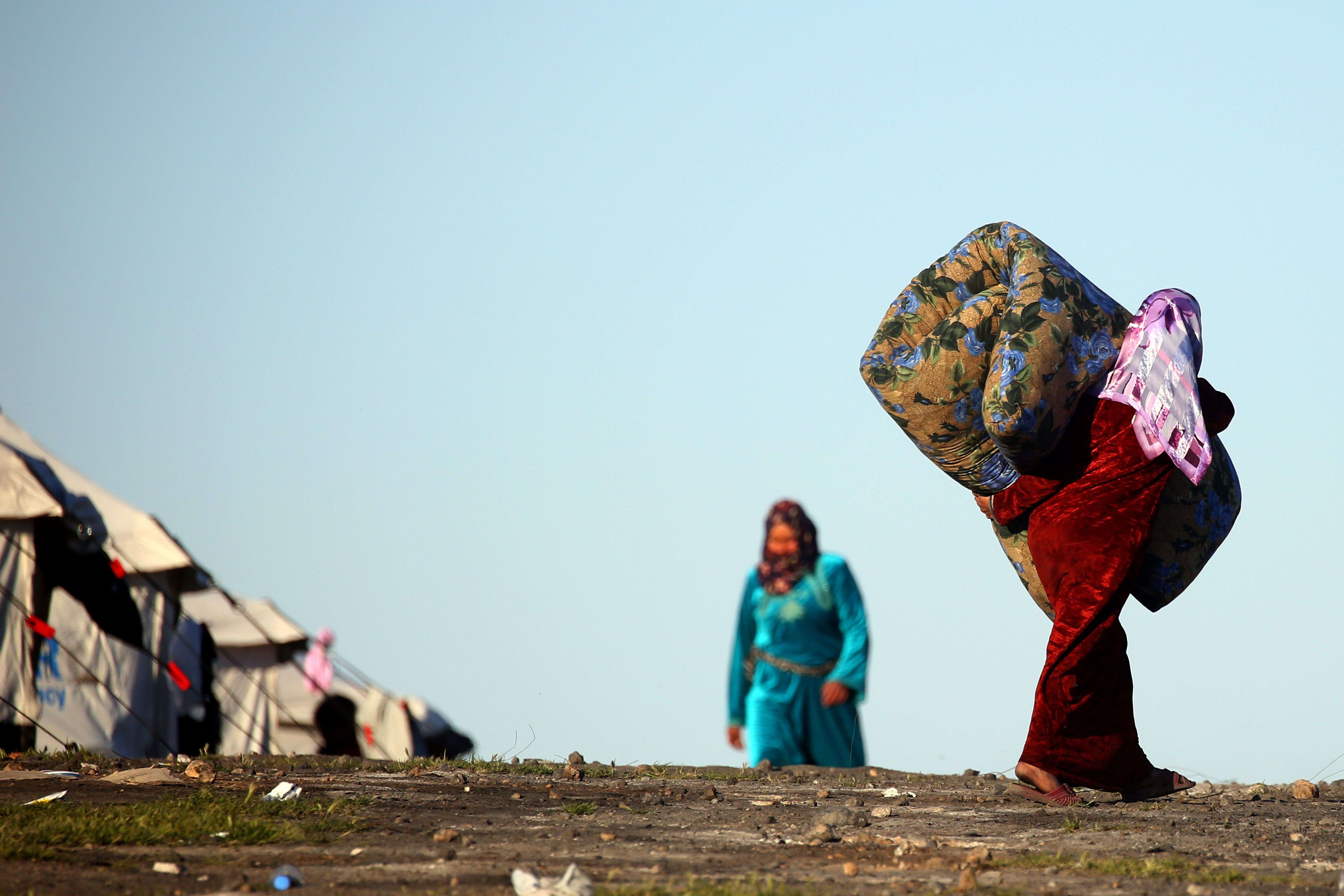 A Syrian woman carries a mattress at a temporary refugee camp in the village of Ain Issa, which houses people who fled Islamic State’s Syrian stronghold in Raqa. Syria lies in ruins. The total death toll lies somewhere between 320,000 and 470,000. More than 10 million people have been driven from their homes; half of them have fled abroad. Photo: AFP