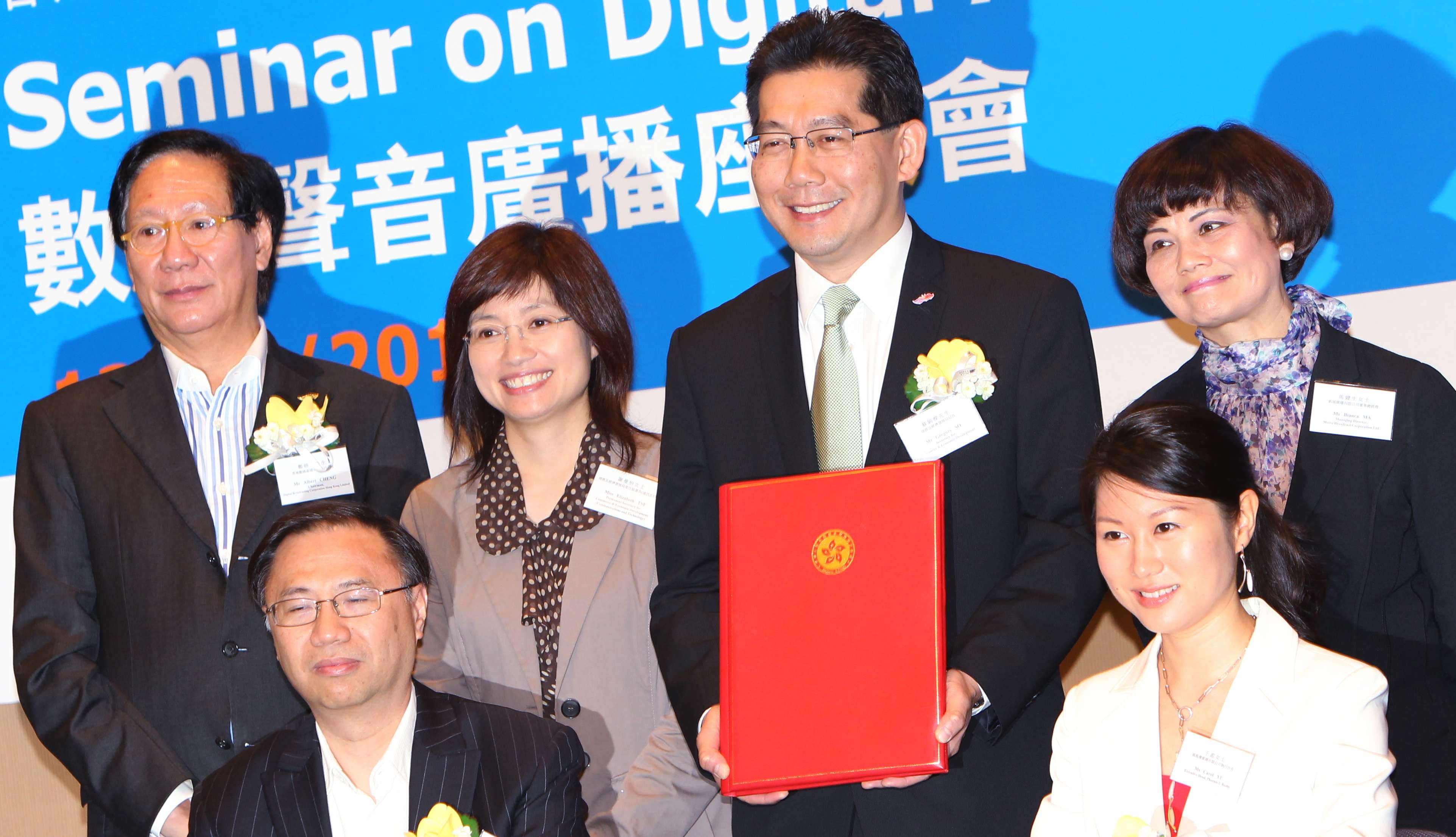 Commerce and Economic Development Secretary Greg So Kam-leung and then permanent secretary Elizabeth Tse Man-yee (back row, second and third right), with top management from Digital Broadcasting Corporation, Metro Broadcast Corporation and Phoenix U Radio, at the signing ceremony for the digital audio broadcasting network sharing agreement at the Convention and Exhibition Centre in Wan Chai, on October 13, 2011. Photo: Felix Wong