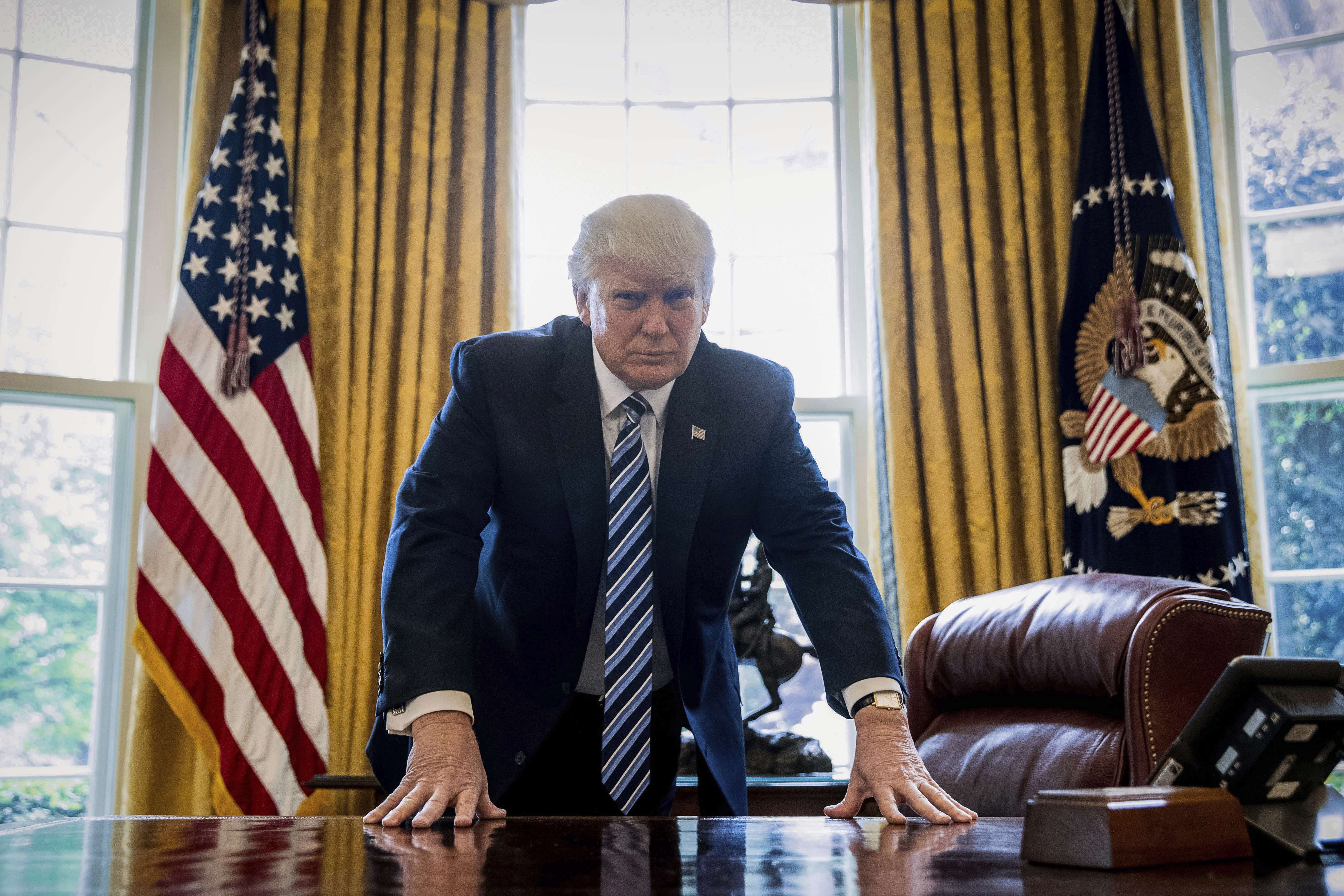 US President Donald Trump poses for a portrait in the Oval Office in Washington, on Friday, April 21. Photo: AP