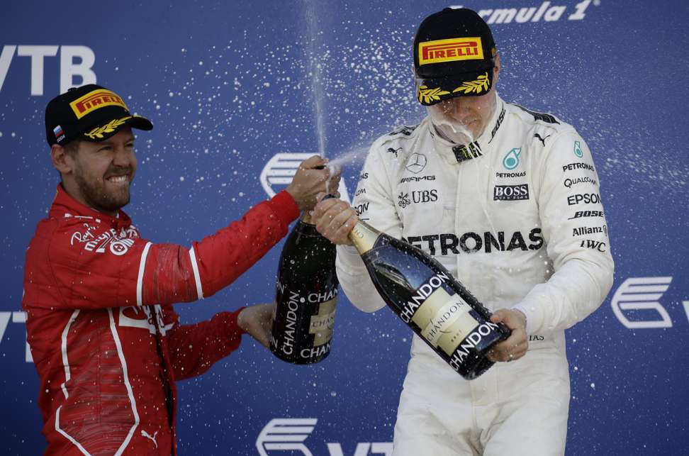 Ferrari’s Sebastian Vettell (left), who finished second, said he was happy for winner Valtteri Bottas. Photo: AP