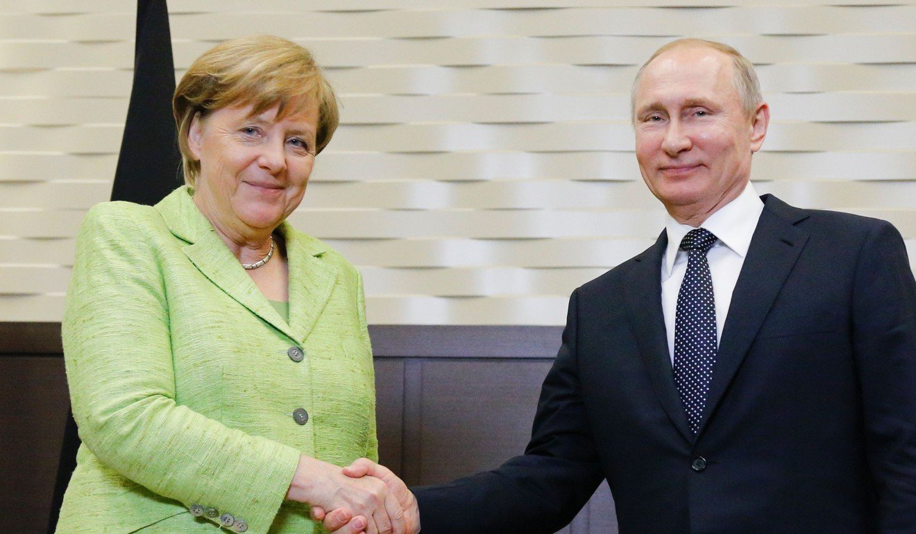 Russian President Vladimir Putin shakes hands with German Chancellor Angela Merkel. Photo: AFP