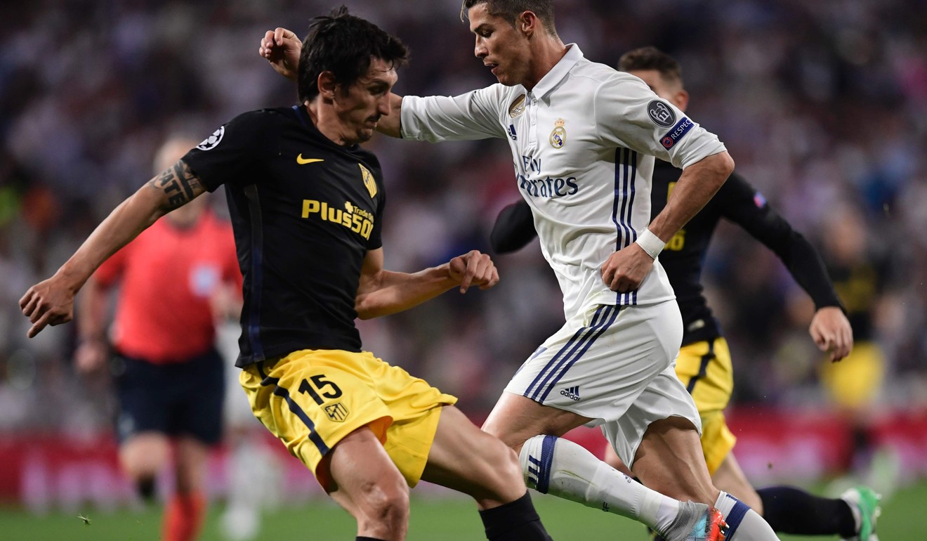Real Madrid's Portuguese forward Cristiano Ronaldo (R) vies with Atletico Madrid's Montenegrin defender Stefan Savic during the UEFA Champions League semi-final first leg football match. Photo: AFP