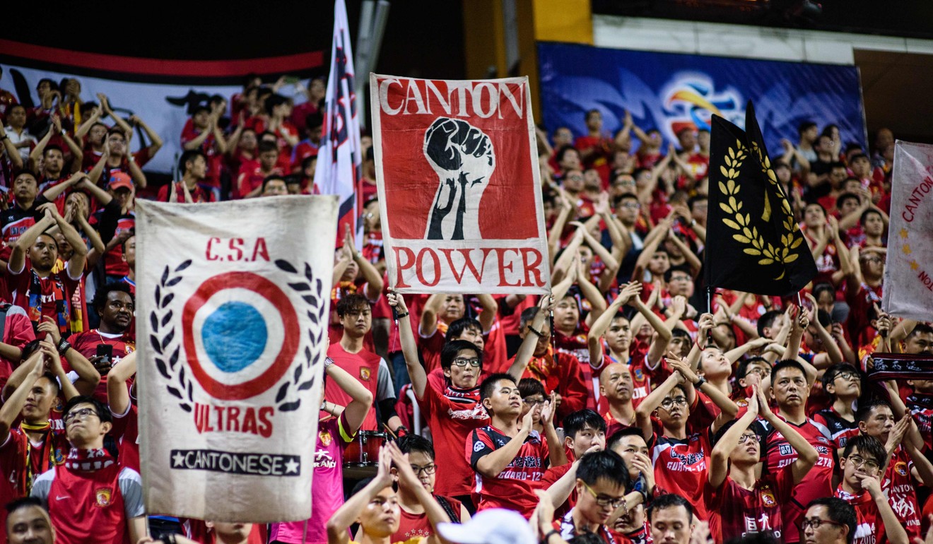 Fans of China's Guangzhou Evergrande hold up banners at Mongkok Stadium. Photo: AFP