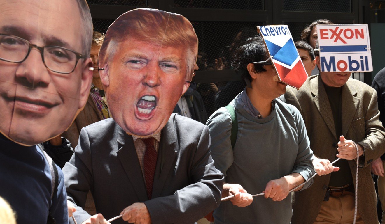 Protesters wear masks during a Trump Tower Divestment Teach-In & Rally at Trump Tower in New York City on May 9, 2017. The group wants New York to fight climate change - by cutting its ties to the dirty oil, coal and gas companies controlling the Trump White House. Photo: AFP