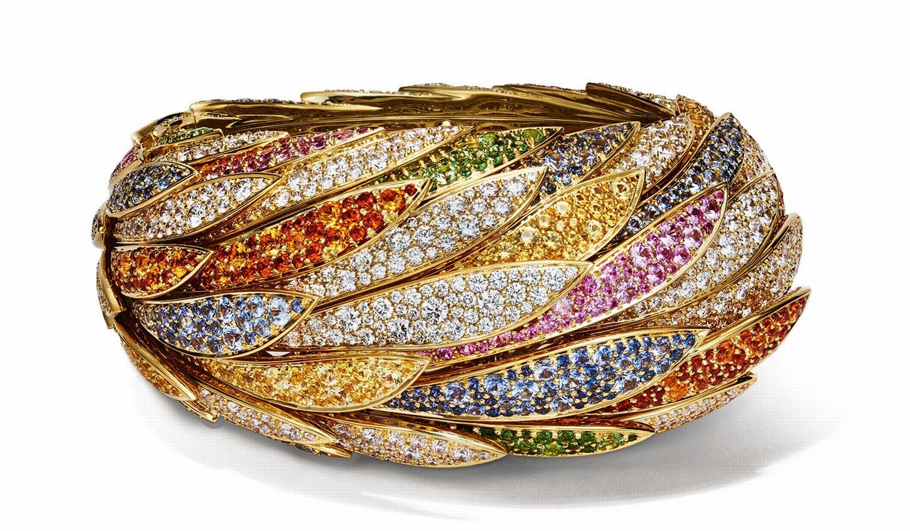 The striking yellow sapphires, blue sapphires and spessartites with the cascading form of the hinged cuff resembles the colourful feathers of exotic birds. Price on request