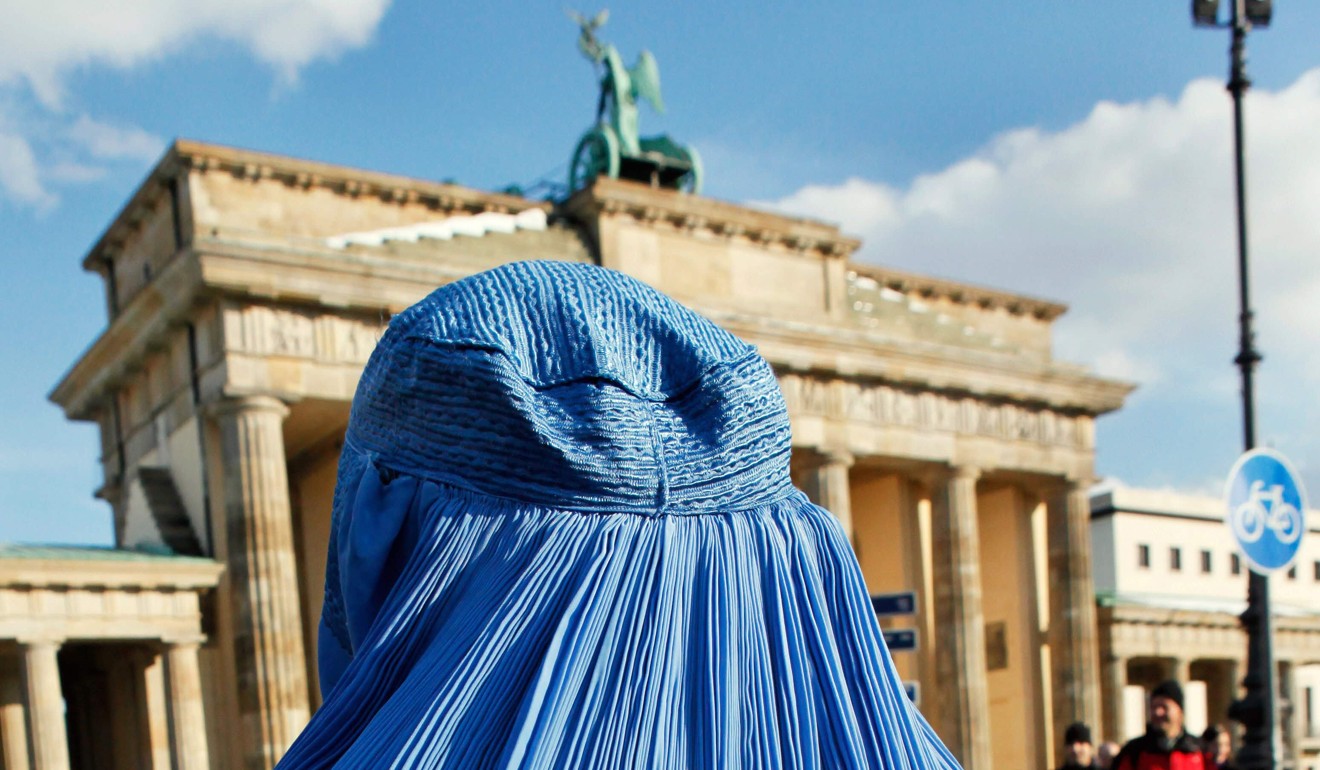 A woman wearing a burqa stands in front of the Brandenburg Gate in Berlin, in 2010. Lawmakers in the lower house of the German parliament last month approved a partial ban on the full-face burqa. Photo: AFP