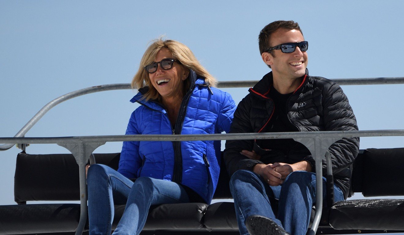 Emmanuel Macron and his wife Brigitte sitting on a chairlift on their way to the mountain top for a lunch break. Photo: AFP
