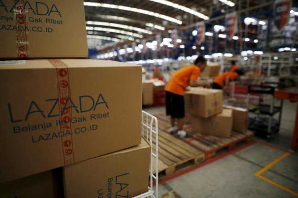Lazada's employees fill orders at the compny’s warehouse in Jakarta. Photo: Reuters