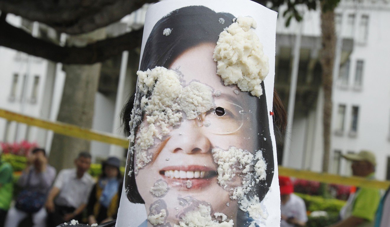 Taiwanese workers throw bean curd at an image of Taiwanese president Tsai Ing-wen during a Labour Day rally in Taipei, as they demand better conditions for workers in Taiwan. Photo: AP