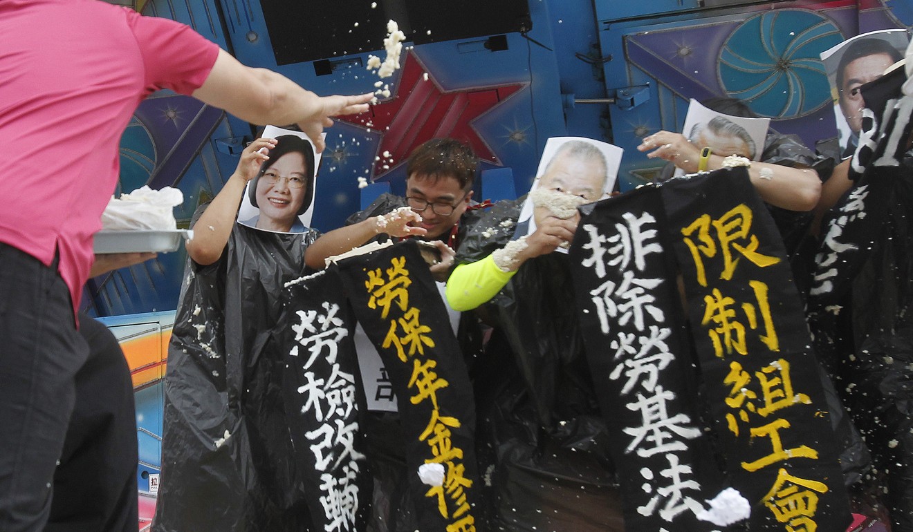 Irate Taiwanese workers hurl bean curd at performers portraying Taiwanese president Tsai Ing-wen during a protest in this May 1 file photo. Photo: AP