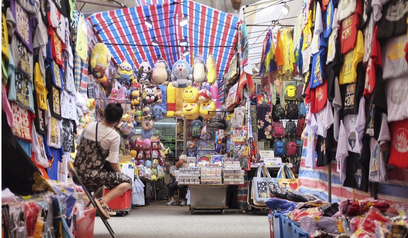 A stall holder relaxes during a moment of calm at the Ladies’ Market in Mong Kok. Photo: Alkira Reinfrank