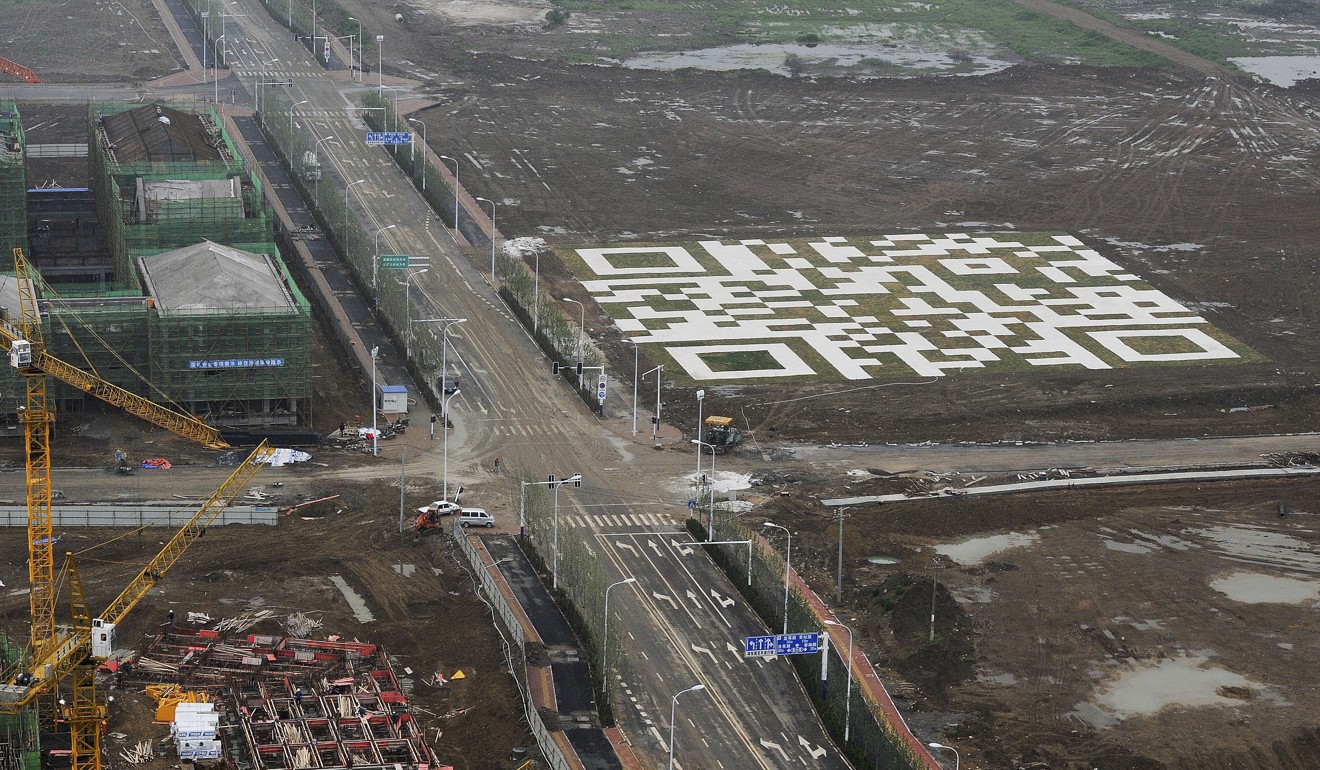 A giant QR code is seen near a housing construction site owned by Chinese developer Vanke in Hefei in Anhui province in this 2013 file photo. The 6,400-square-metre QR code, formed from marbles and lawn, can be scanned by mobile phone to enable the phone to play audio and video content of nature, attracting home buyers. Photo: AP