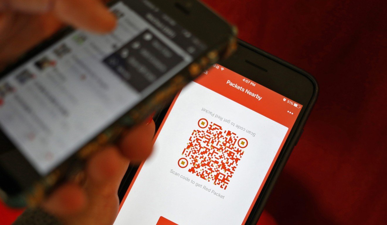 A photo illustration of a WeChat user scanning a QR code to retrieve a digital red envelope on the WeChat app on a mobile phone during the Chinese New Year period in Beijing. Photo: EPA