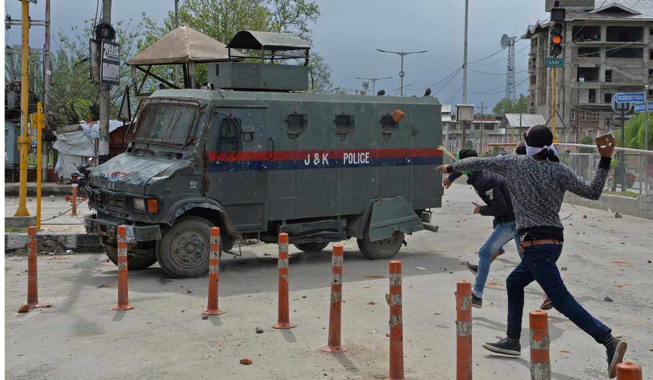 Kashmiri students clash with Indian government forces in central's Srinagar's Lal Chowk. The Indian army has given an award to the soldier who strapped a Kashmiri man to his jeep for use as a human shield. Photo: AFP