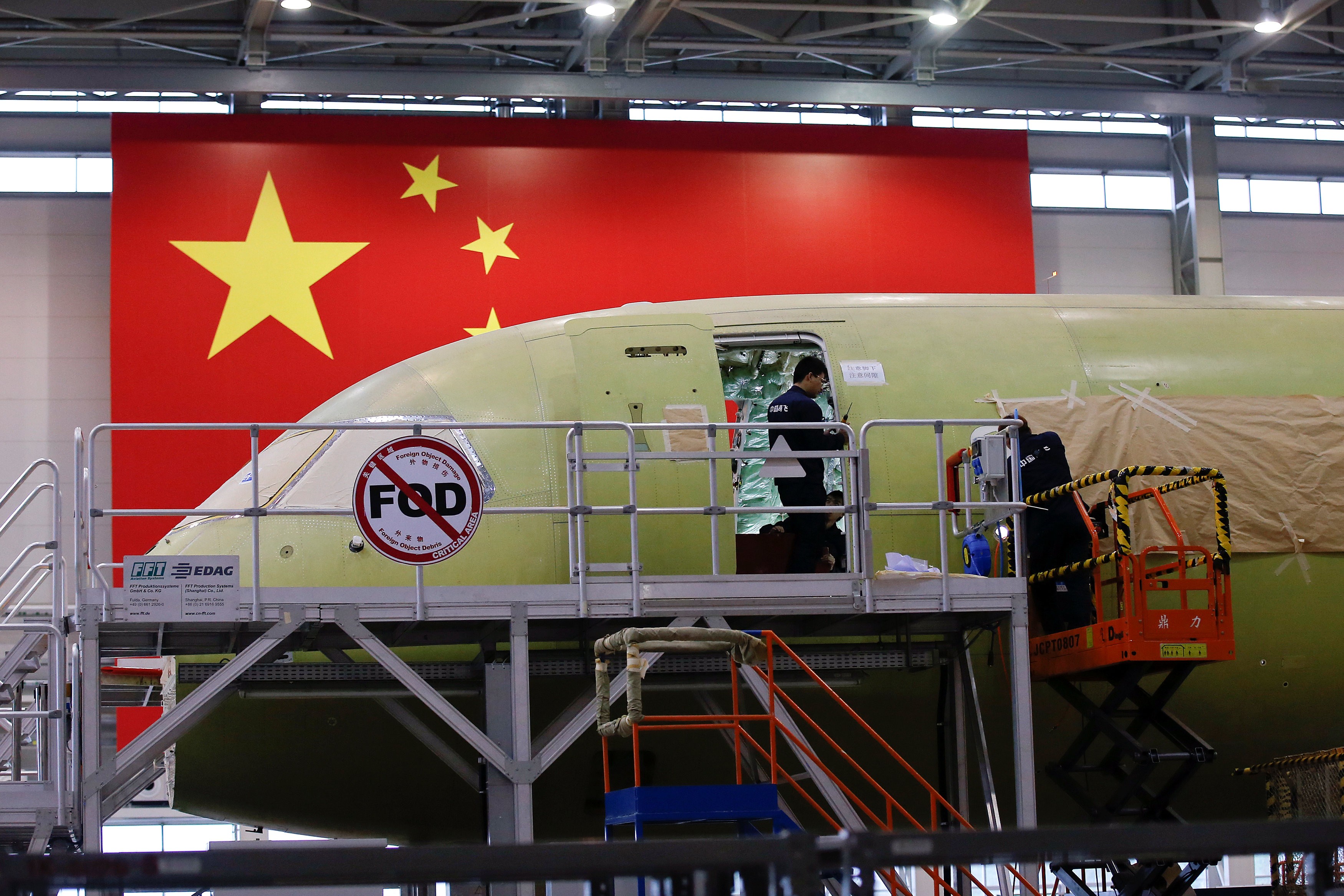 Employees work on China's home-grown C919 passenger jet in Shanghai earlier this month. The plane made its maiden flight on May 5. Photo: Reuters