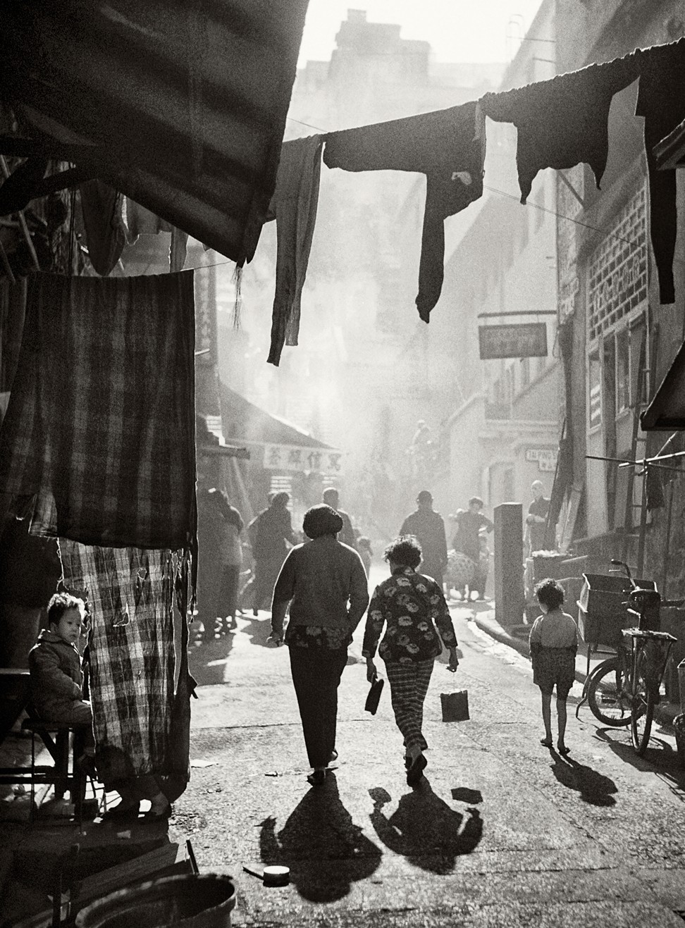 Strolling to Tai Ping Shan Street, , a photo from Fan Ho’s series portraying Hong Kong in the 1950s and 1960s. Photo: Fan Ho