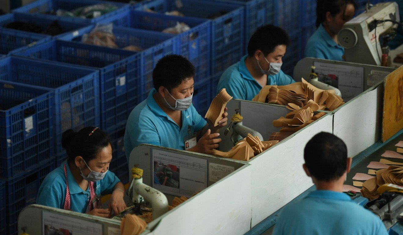 Workers on a production line at the Huajian shoe factory in Dongguan, Guangdong province. Photo: AFP