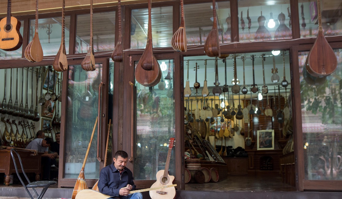 A craftsman outside a musical instrument shop in Kashgar. Photo: Xinhua
