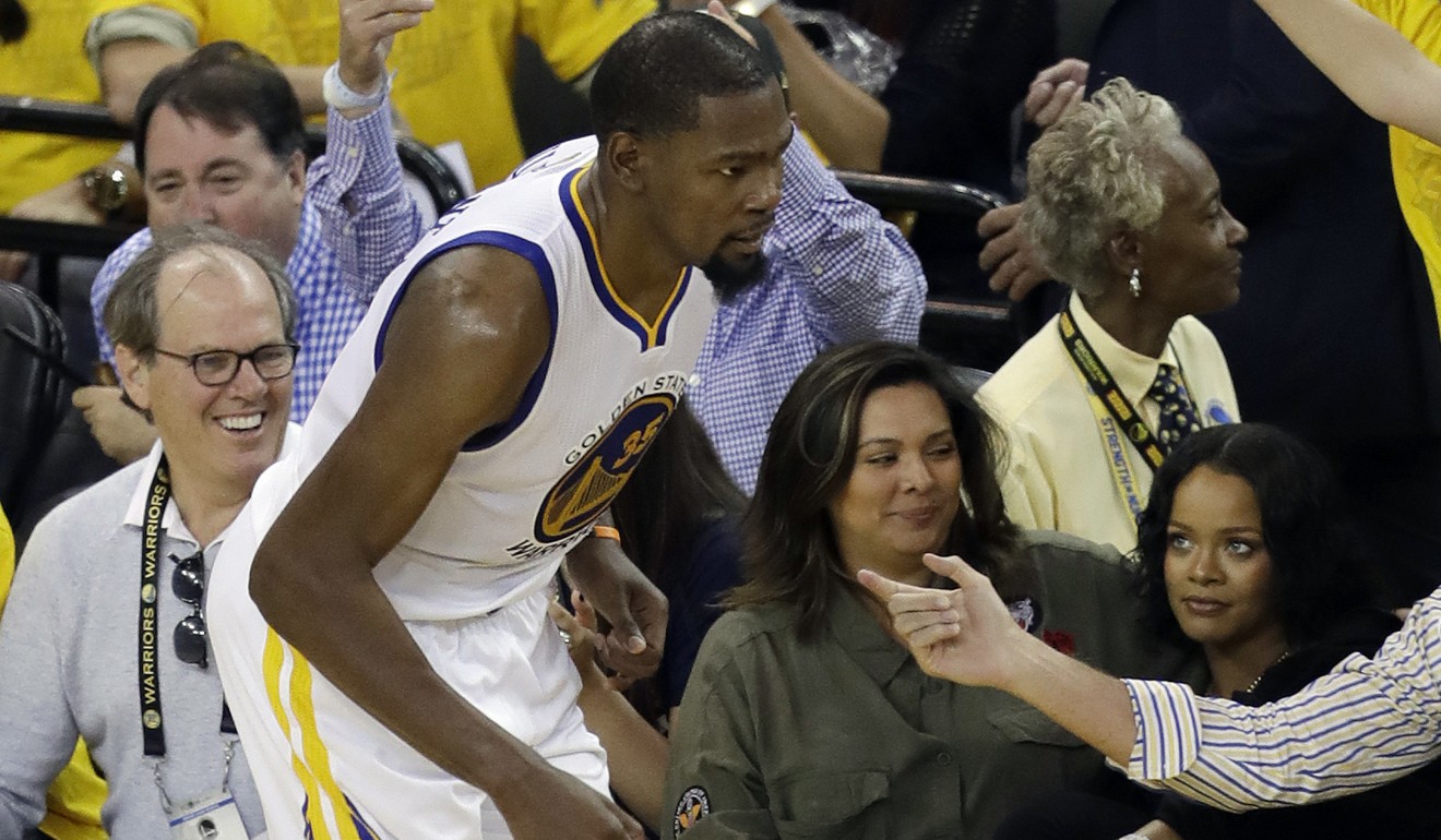 Rihanna (right) watches as Golden State Warriors' Kevin Durant. Photo: AP