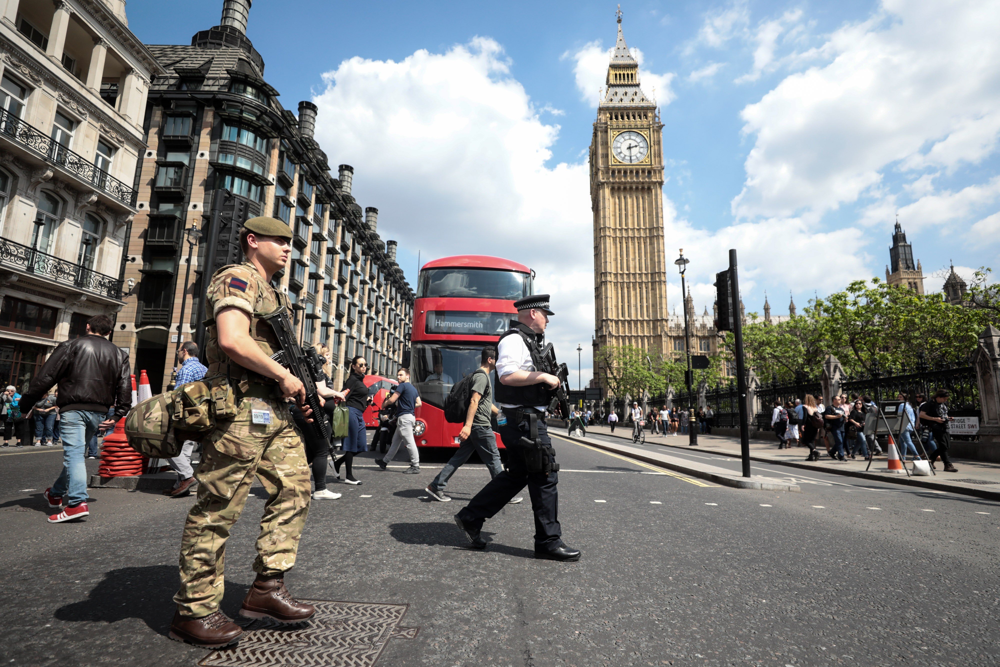 A soldier and an armed police officer patrol near the Elizabeth Tower, also known as Big Ben, in London on May 24. Photo: Bloomberg