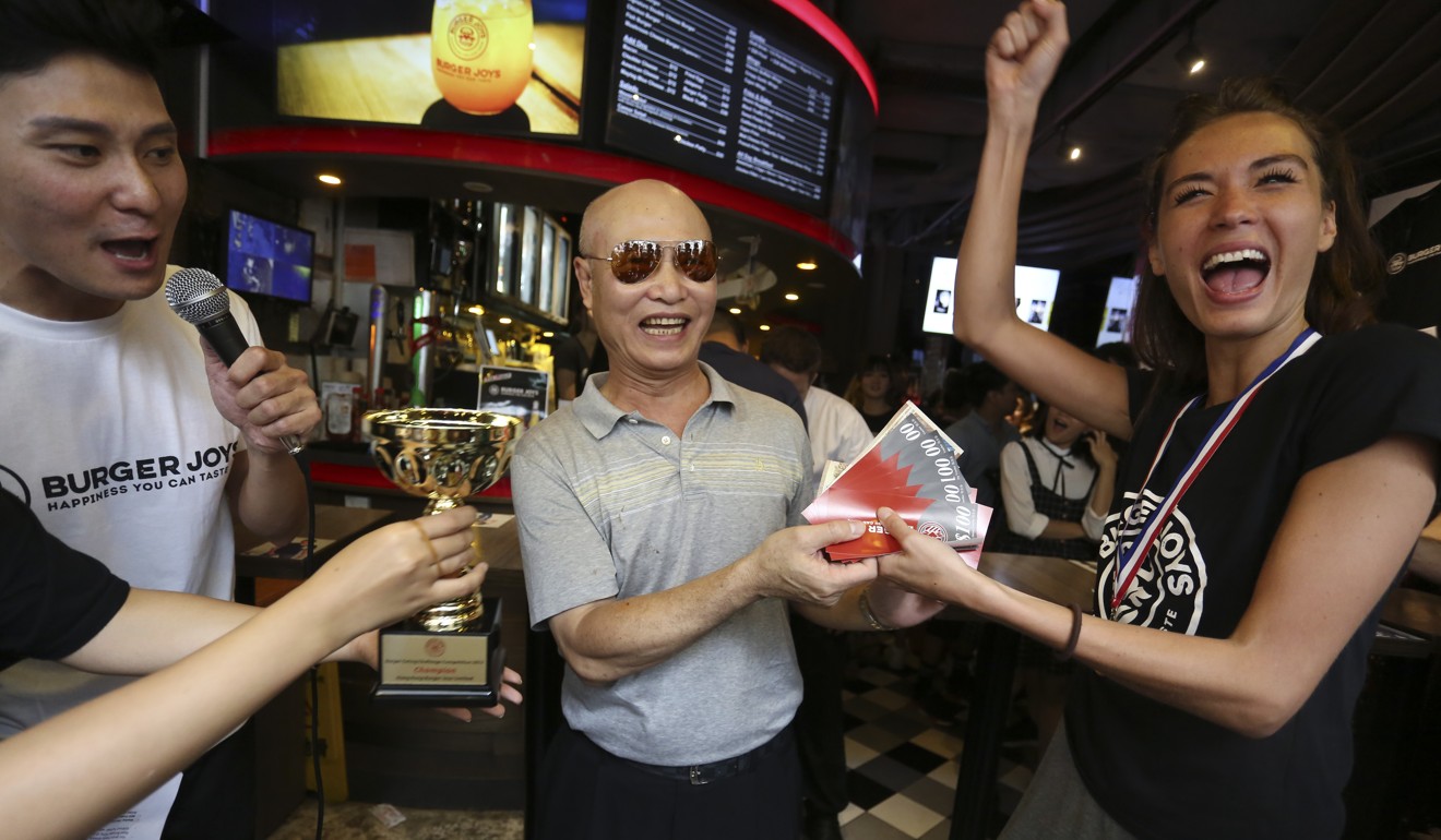 Natalie Wood celebrates after she is crowned the winner of the burger eating challenge. Photo: Jonathan Wong