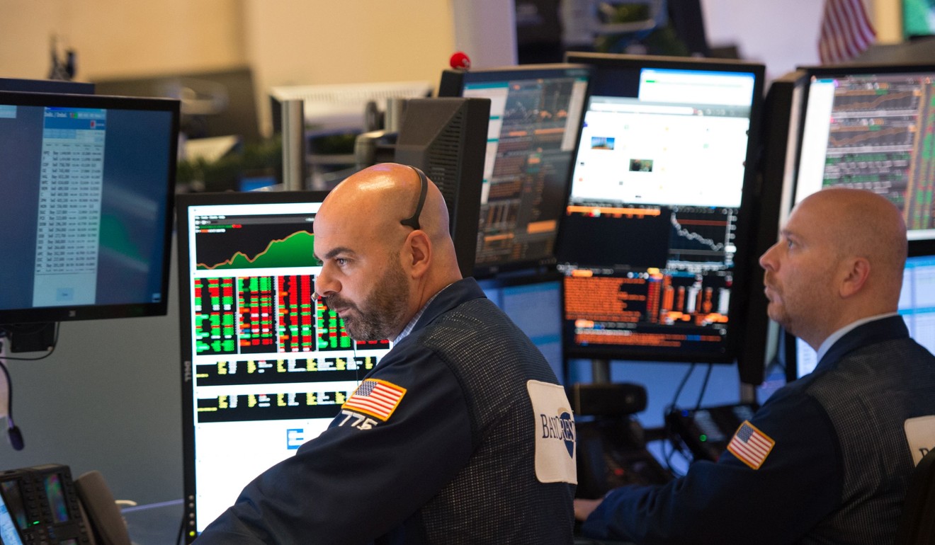 Traders work on the floor of the New York Stock Exchange at the closing bell of the Dow Jones Industrial Average on June 8, 2017 in New York. Wall Street stocks ended higher Thursday as investors took in stride dramatic testimony from ousted FBI chief James Comey on his firing by President Donald Trump and links to the Russia investigation. Photo: AFP