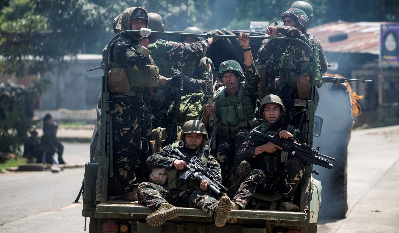Soldiers on a vehicle on a street in Marawi. Photo: AFP