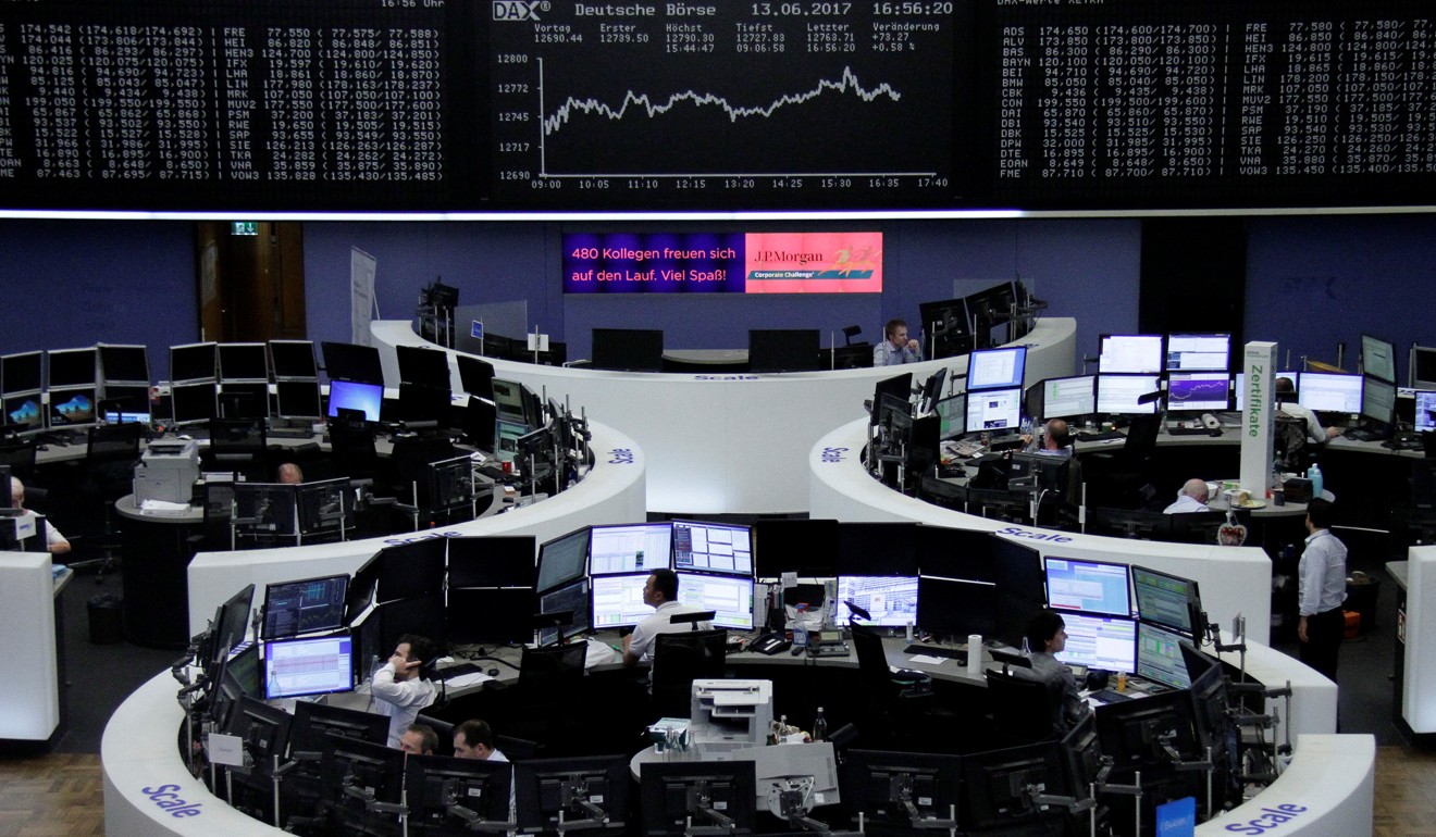 Traders work in front of the German share price index, DAX board, at the stock exchange in Frankfurt, Germany. European shares posted gains in trading on Tuesday, June 13, 2017. Photo: Reuters