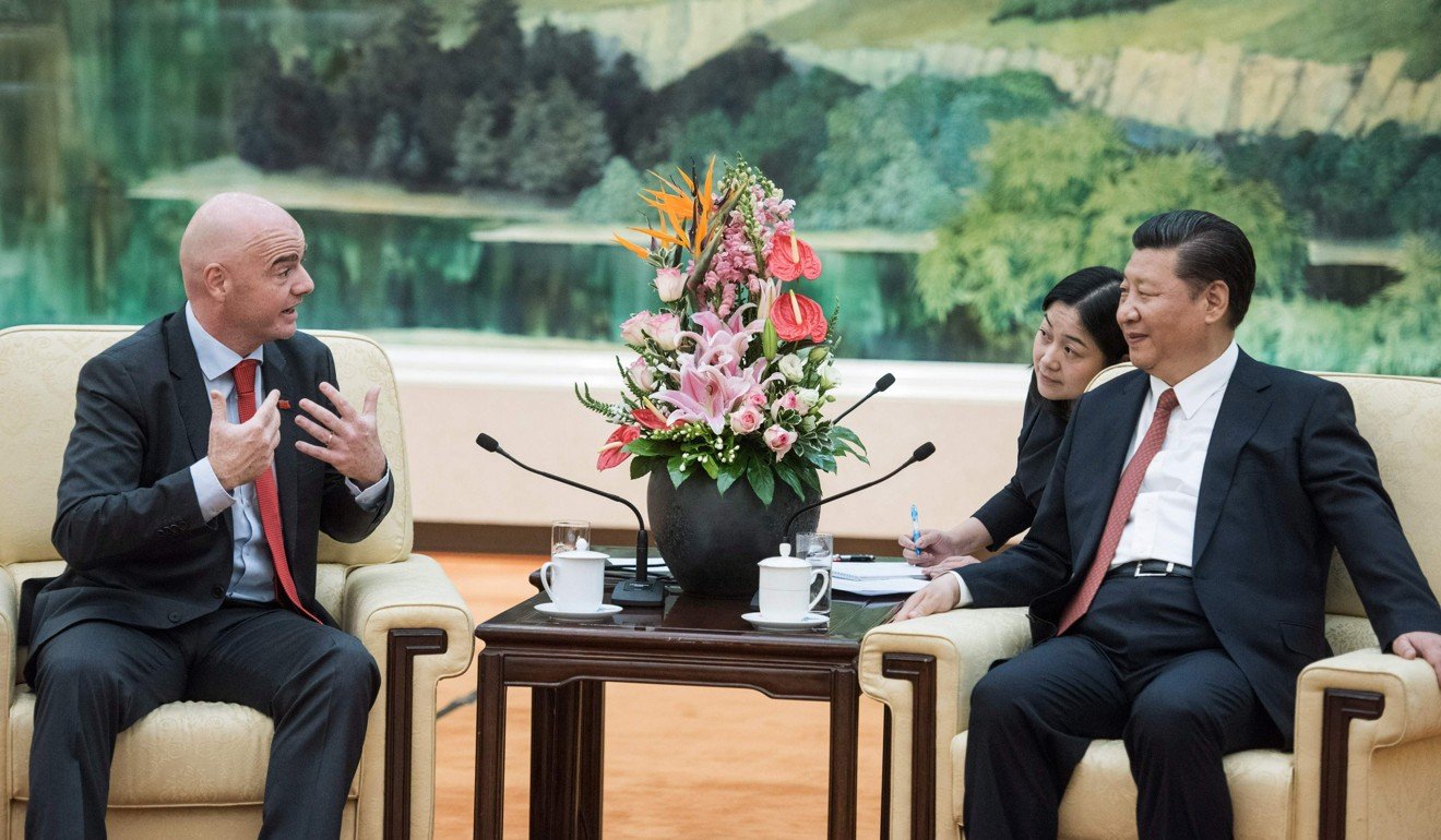 Xi Jinping listens to Fifa president Gianni Infantino. Photo: AFP
