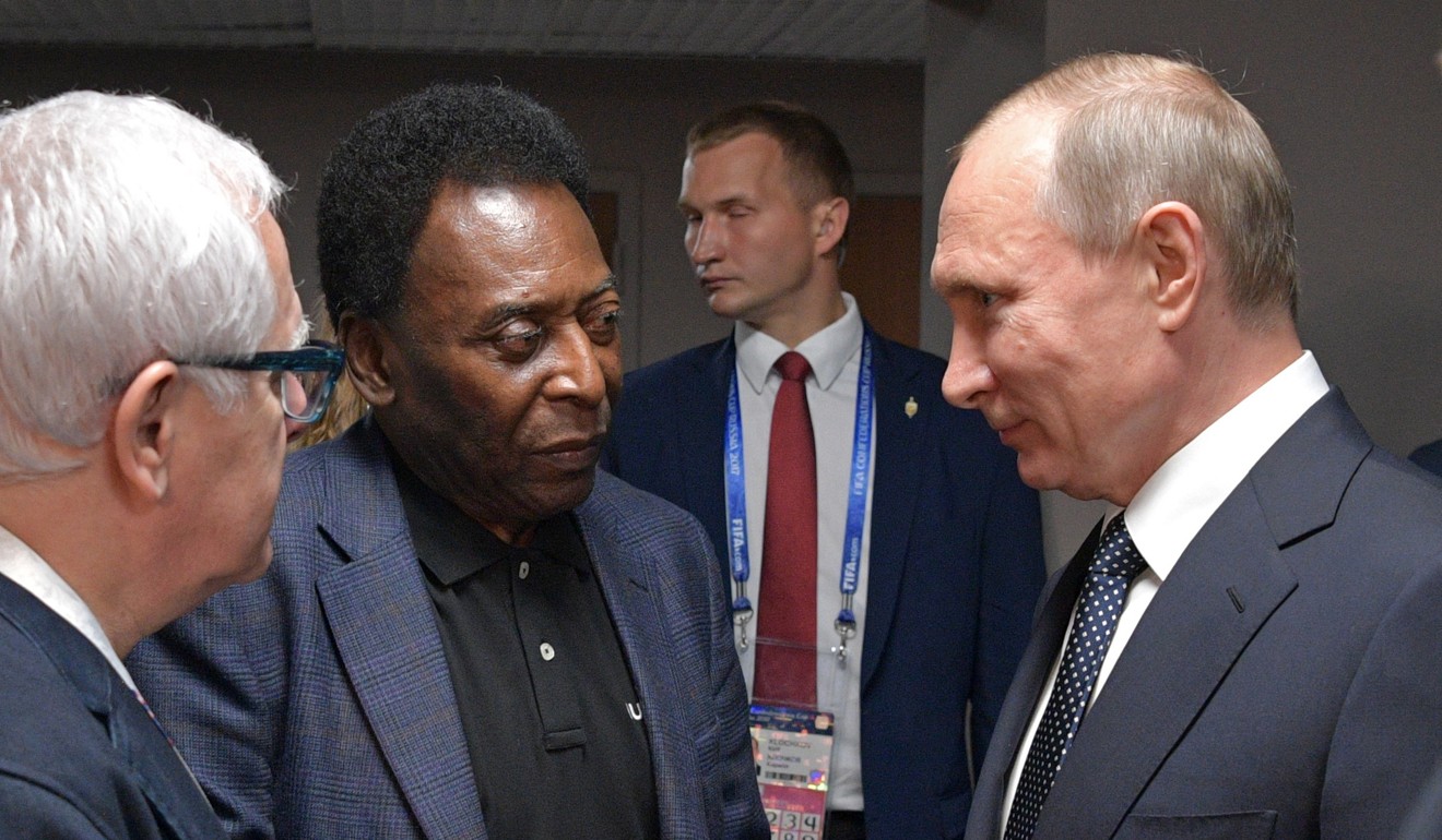Vladimir Putin (right) speaks to Pele. Photo: AP
