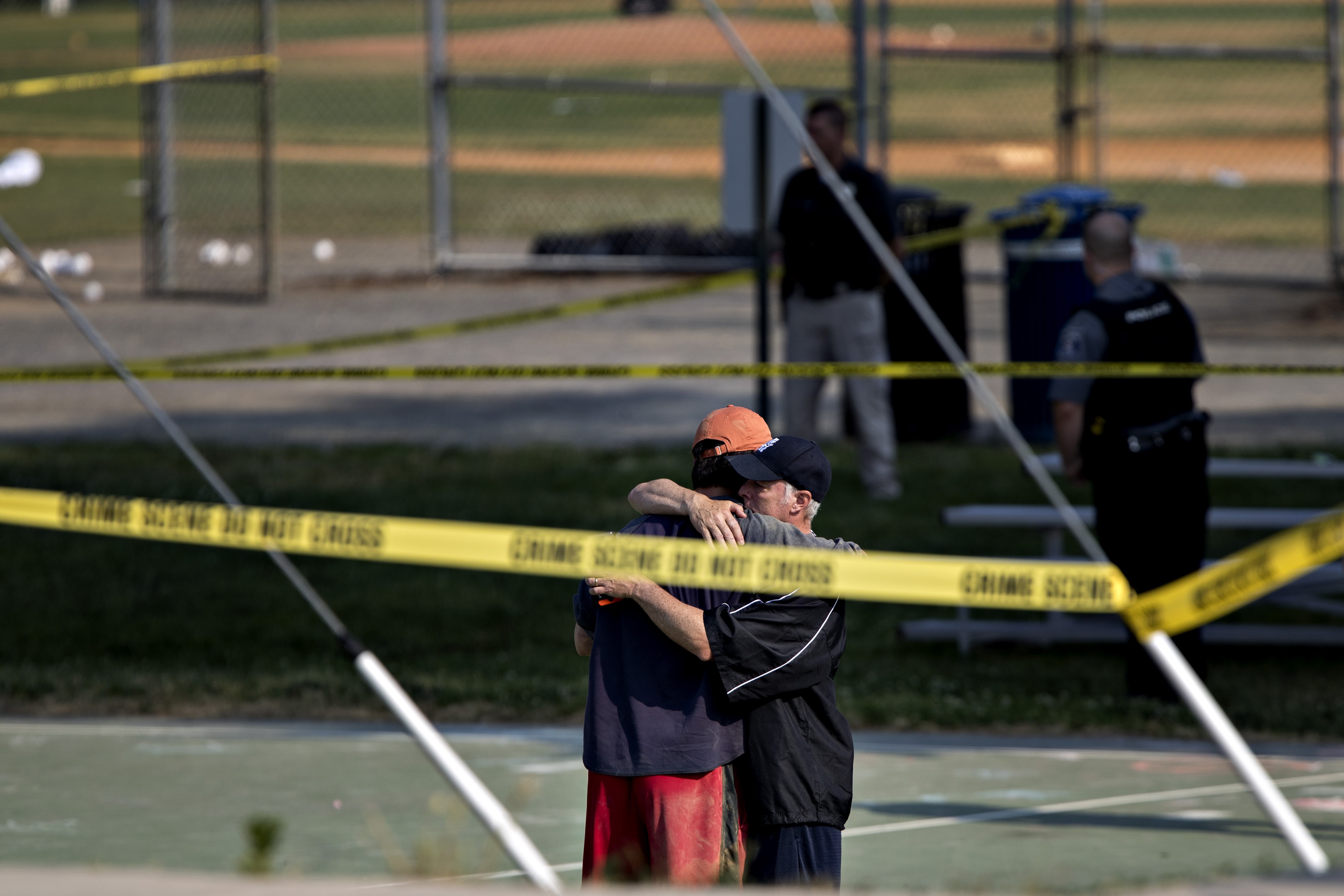 Two people hug in front of police crime scene tape following the shootings during a congressional baseball practice at the Eugene Simpson Stadium Park in Alexandria, Virginia, on June 14. Photo: Bloomberg