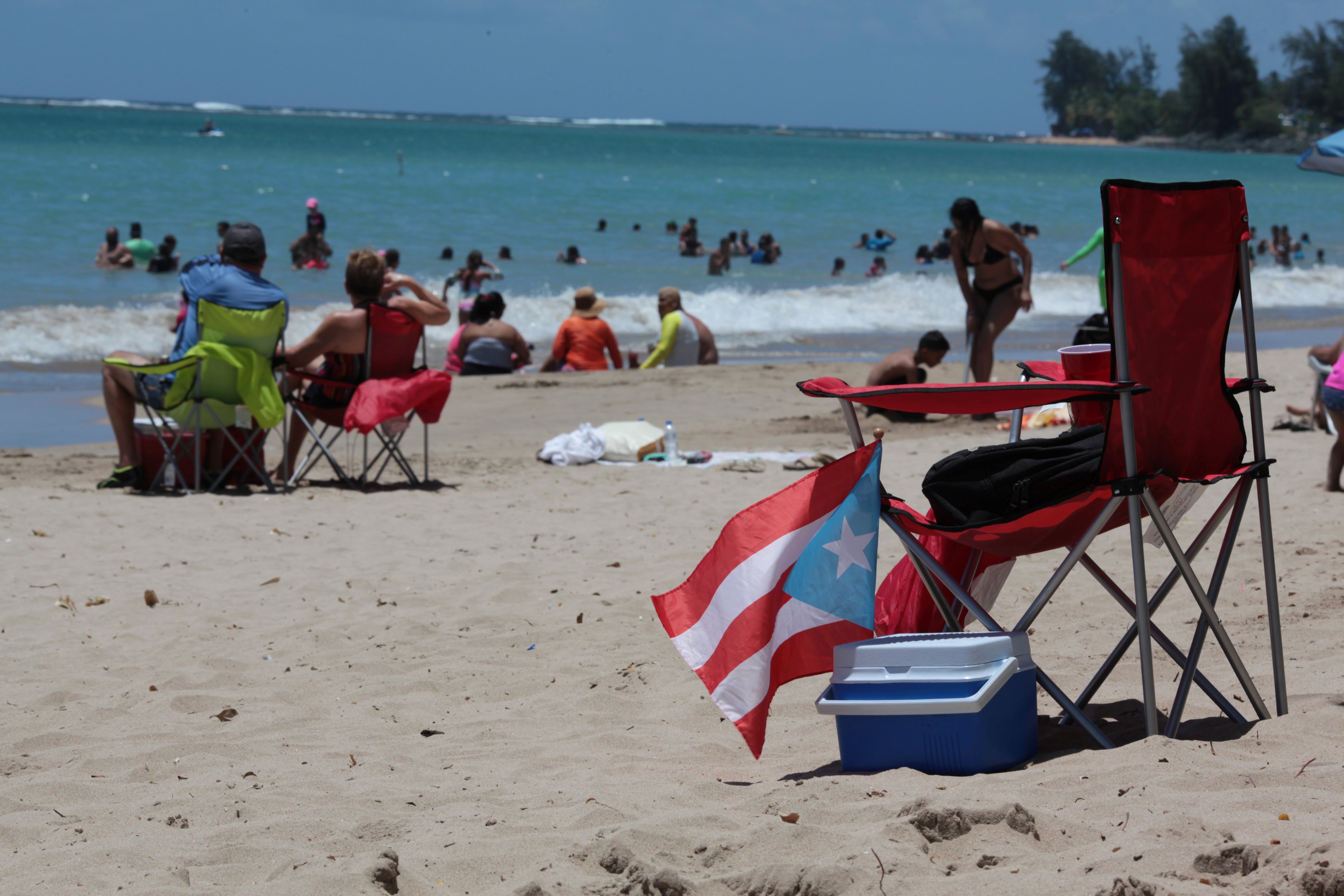 People spend time at the beach on June 11 as Puerto Ricans headed to the polls to vote in a referendum on the future of the US territory. Photo: Reuters
