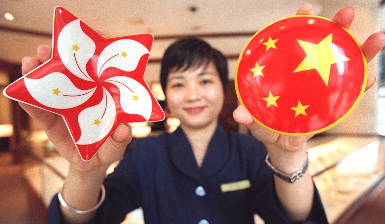 A shop assistant for Tiffany’s jewellers in Central, Hong Kong, with porcelain ‘Handover’ souvenir boxes for sale in 1997. Photo: AFP