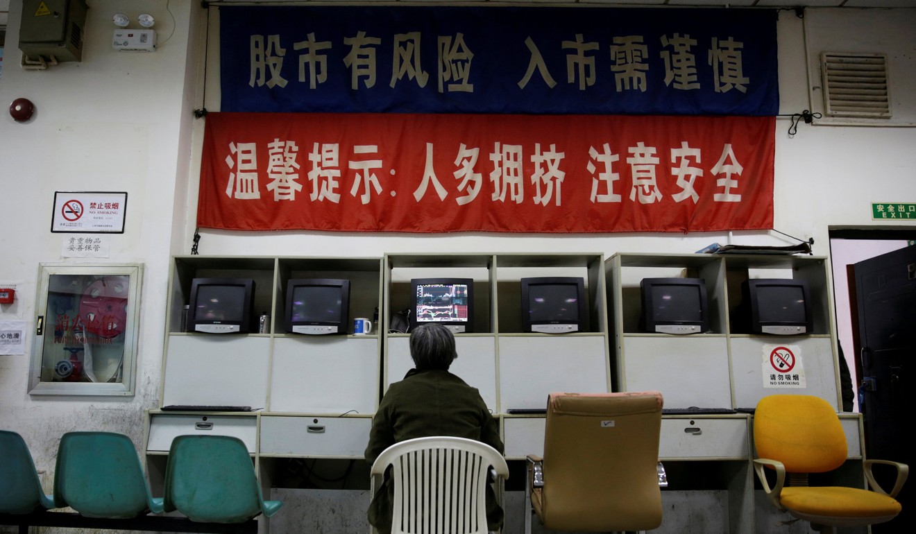 An investor at a brokerage house in Shanghai, China. Photo: Reuters