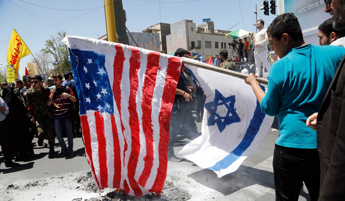 Iranians burn US and Israeli flags during a rally marking Quds Day. Photo: EPA