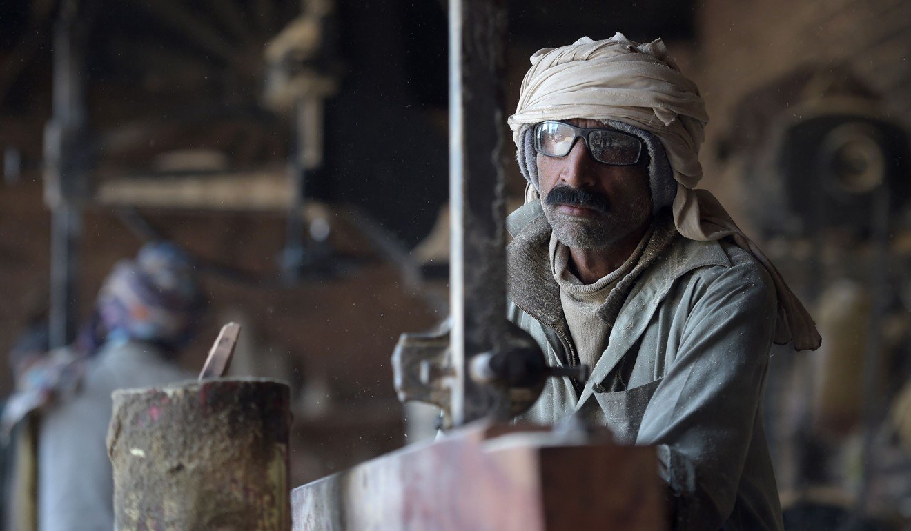 Maqsood Ahmed, who sold one of his kidneys, works at a wood workshop in Bhalwal in Sargodha District, in Pakistan's Punjab Province. Photo: AFP