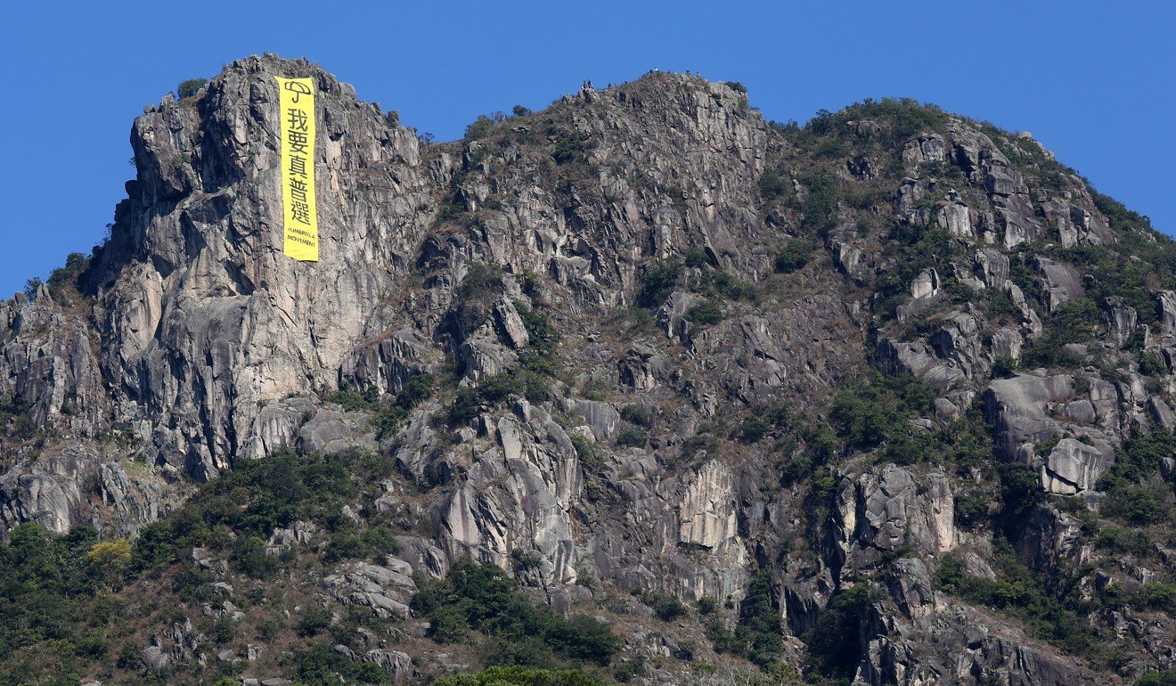 A yellow pro-democracy banner with the words 