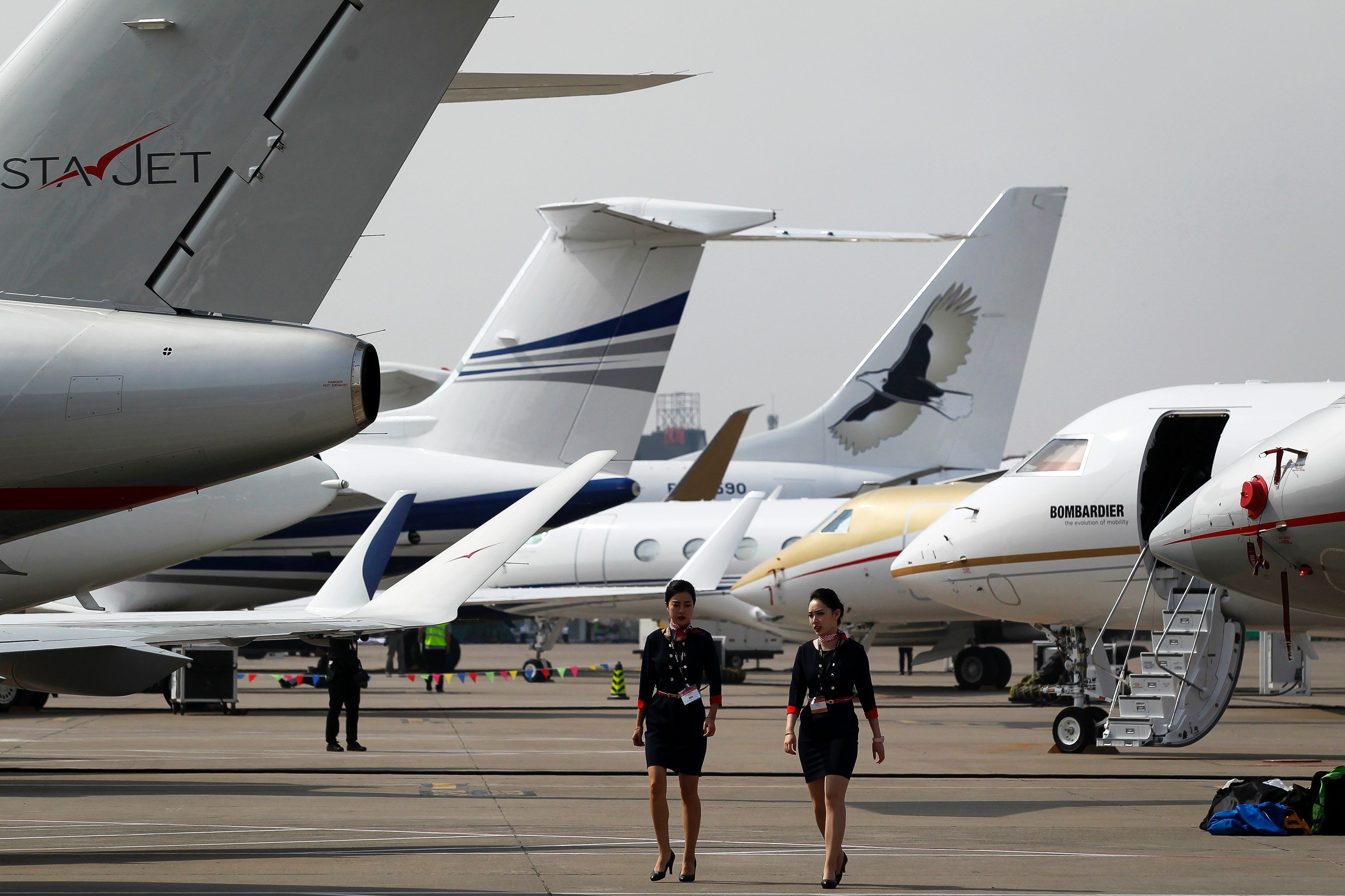 Crew members walk past business jets ahead of the Asian Business Aviation Conference and Exhibition at Shanghai’s Hongqiao Airport last April. Entrepreneurs in mainland China, Hong Kong and Taiwan wishing to charter personal jets currently have fewer options than counterparts elsewhere in Asia. Photo: AFP