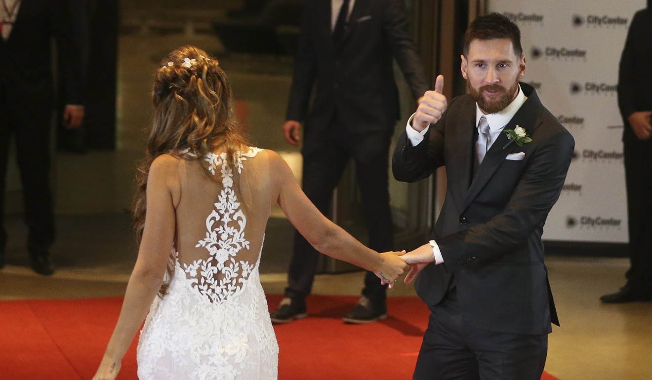 Lionel Messi and his wife Antonella Roccuzzo exit the venue after their wedding. Photo: EPA