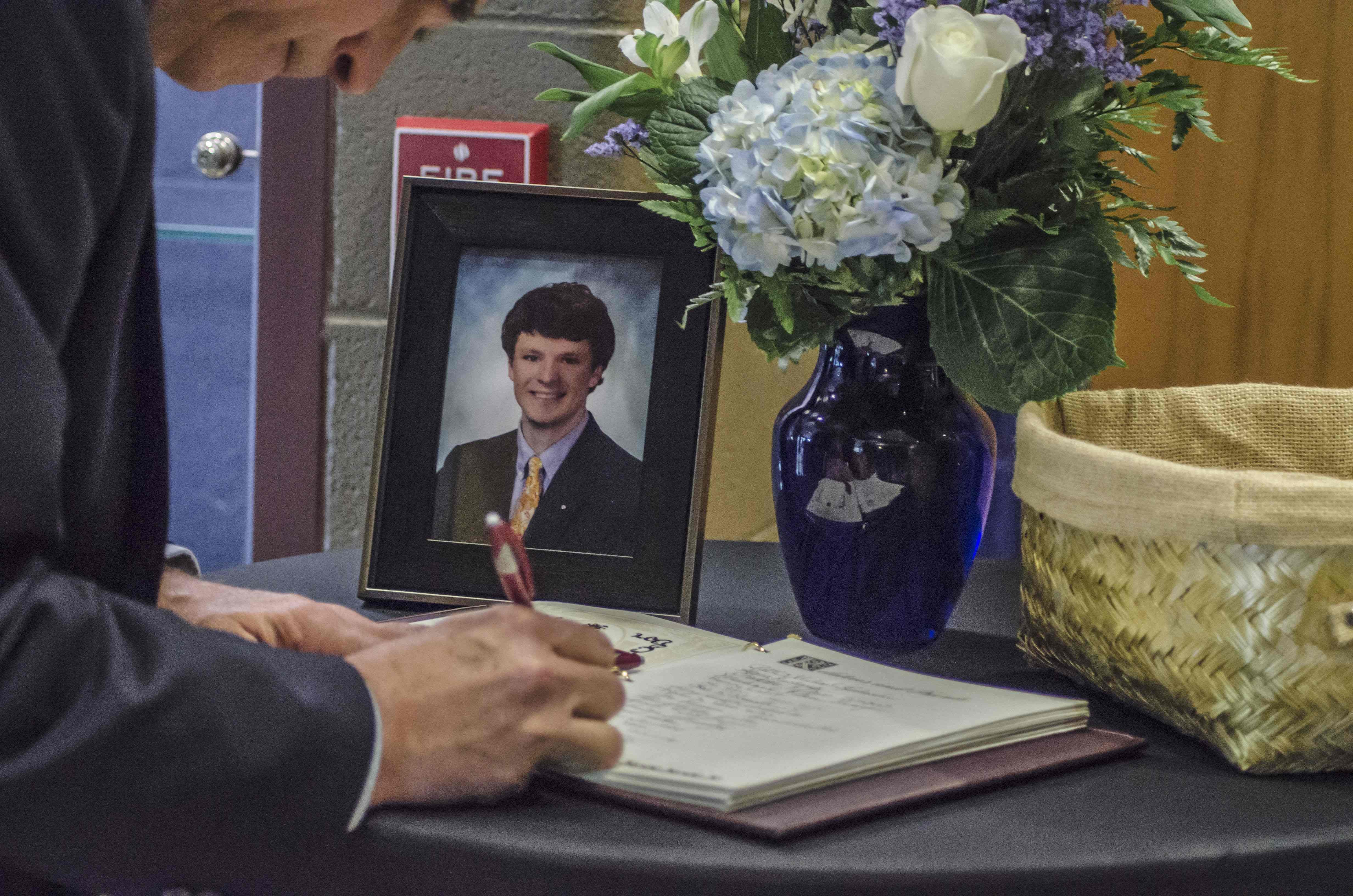 A mourner signs a guest book at Otto Warmbier’s funeral. Picture: AFP
