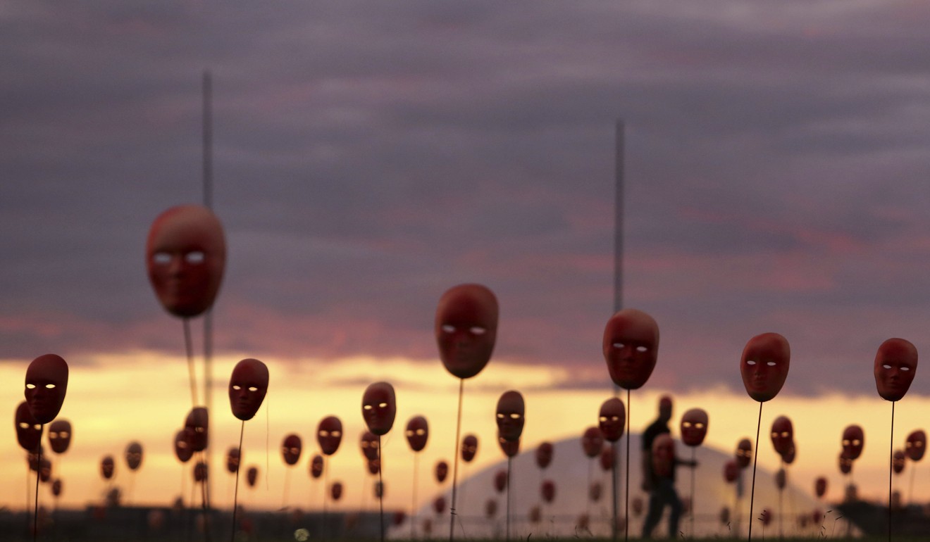 Masks representing corrupt politicians line the lawn outside the National Congress building, in Brasilia, Brazil. Photo: AP