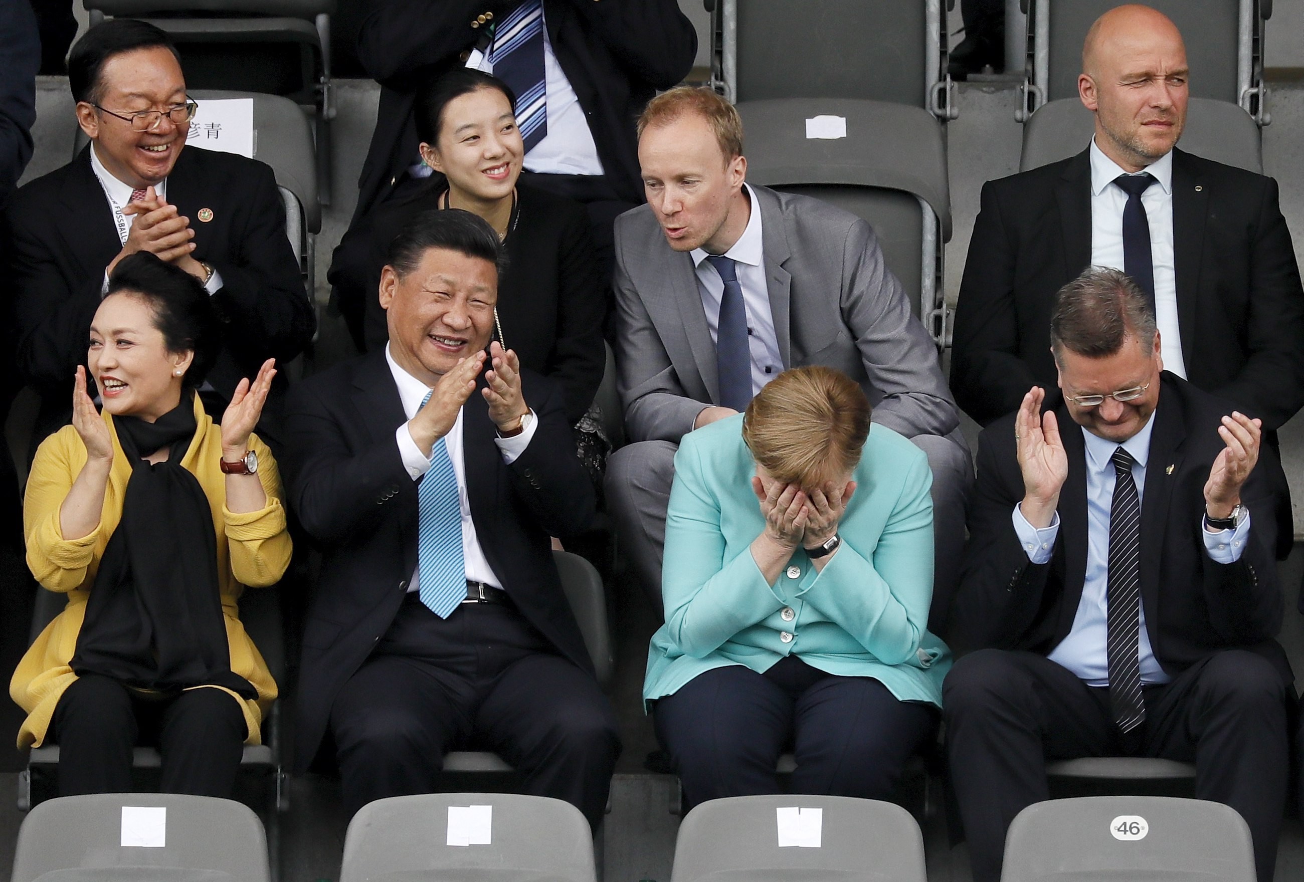 President Xi Jinping (second from left) and his wife Peng Liyuan (left) watch an under-12 soccer game with German Chancellor Angela Merkel (third from left), in Berlin last week. Xi’s love of the game is well known. Photo: EPA